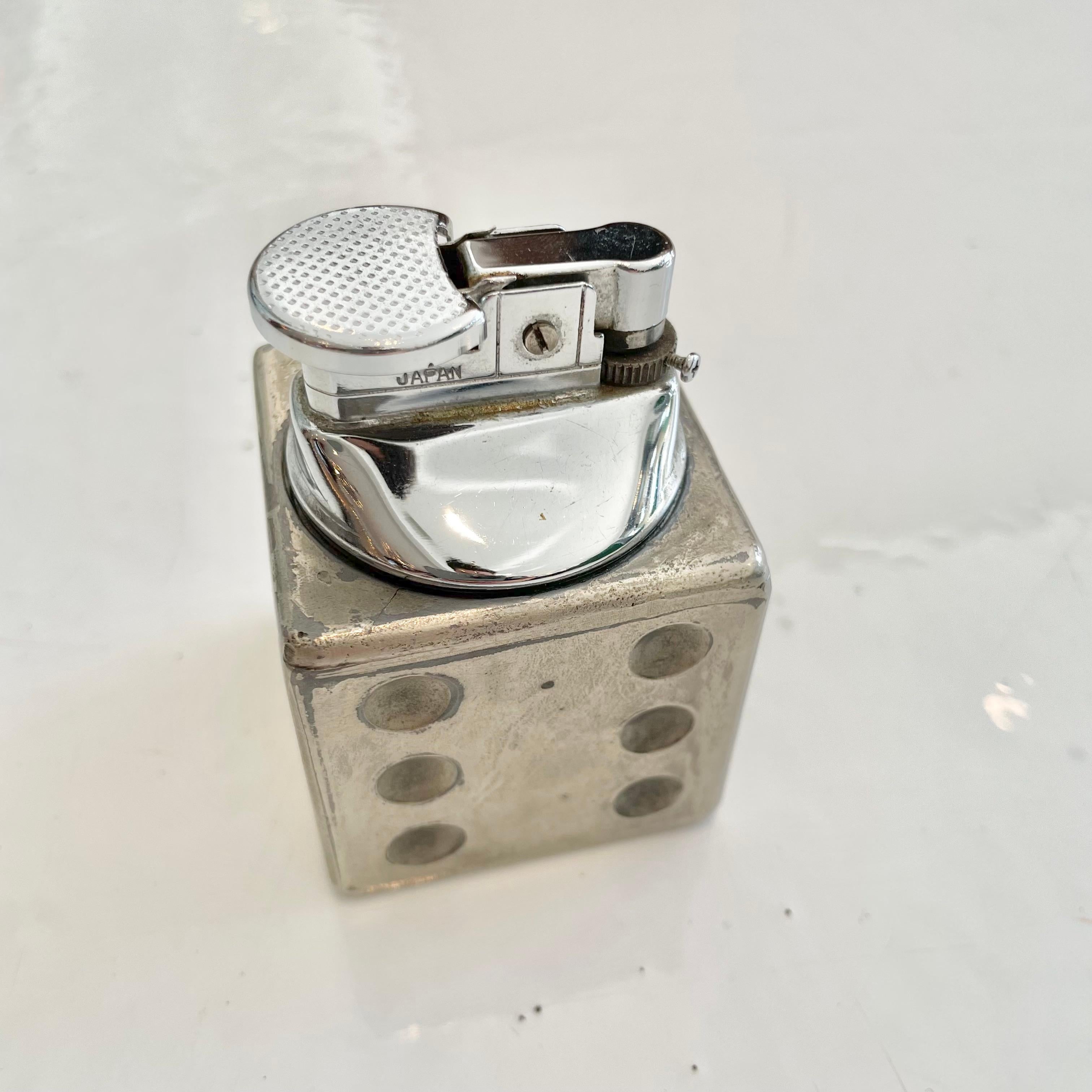 Fun vintage table lighter in the shape of a dice. Made in Japan. Great patina and personality. Cool tobacco accessory and conversation piece. Working lighter. Great vintage condition.