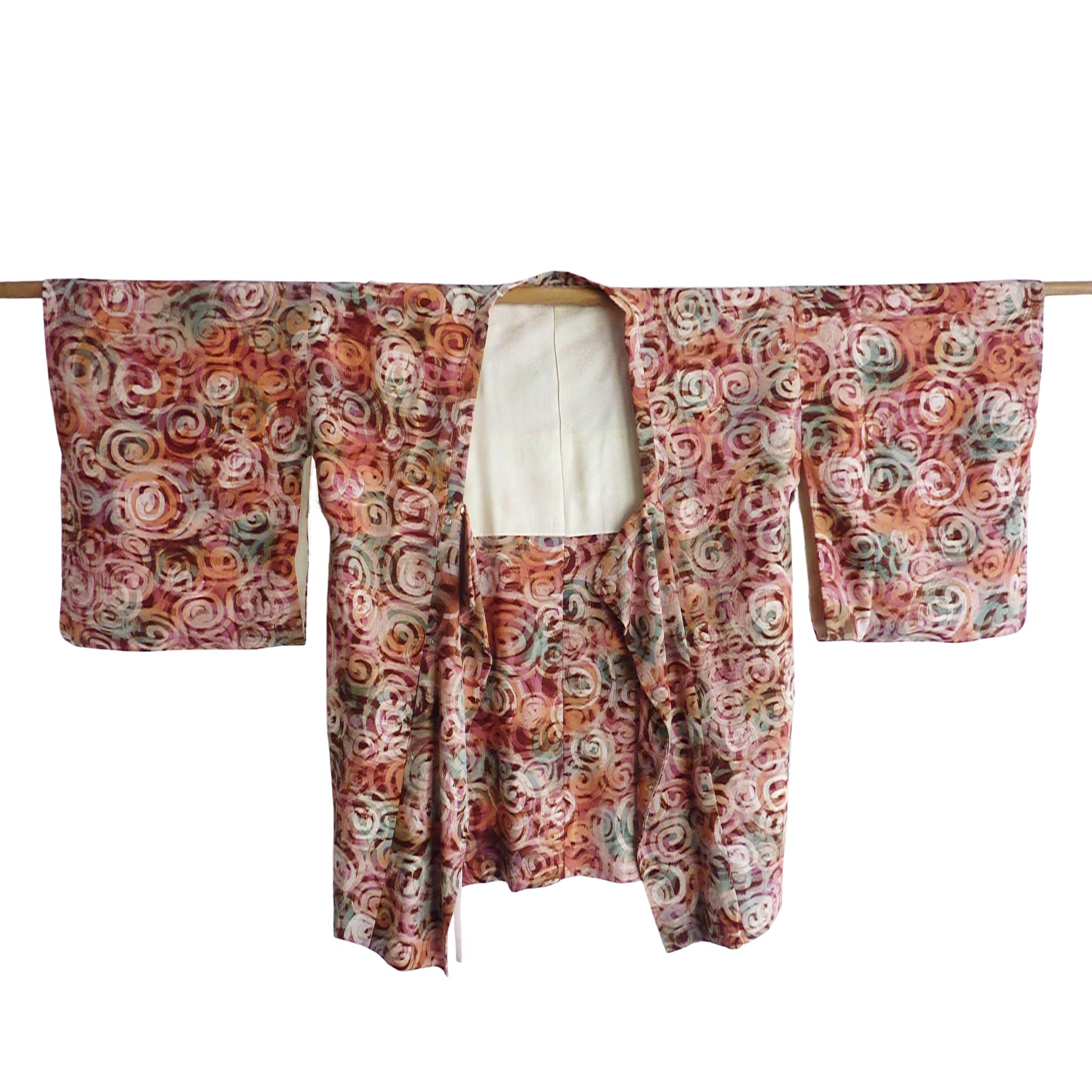 Rare kimono avec des boutons et une profonde chute des manches.
Circa : 1920s
Lieu d'origine : Japon
Matériau : Soie. Doublure en jacquard de soie.
Quelques fils perdus. 
Longueur totale 34 cm.  Manchon d'un bout à l'autre : 48