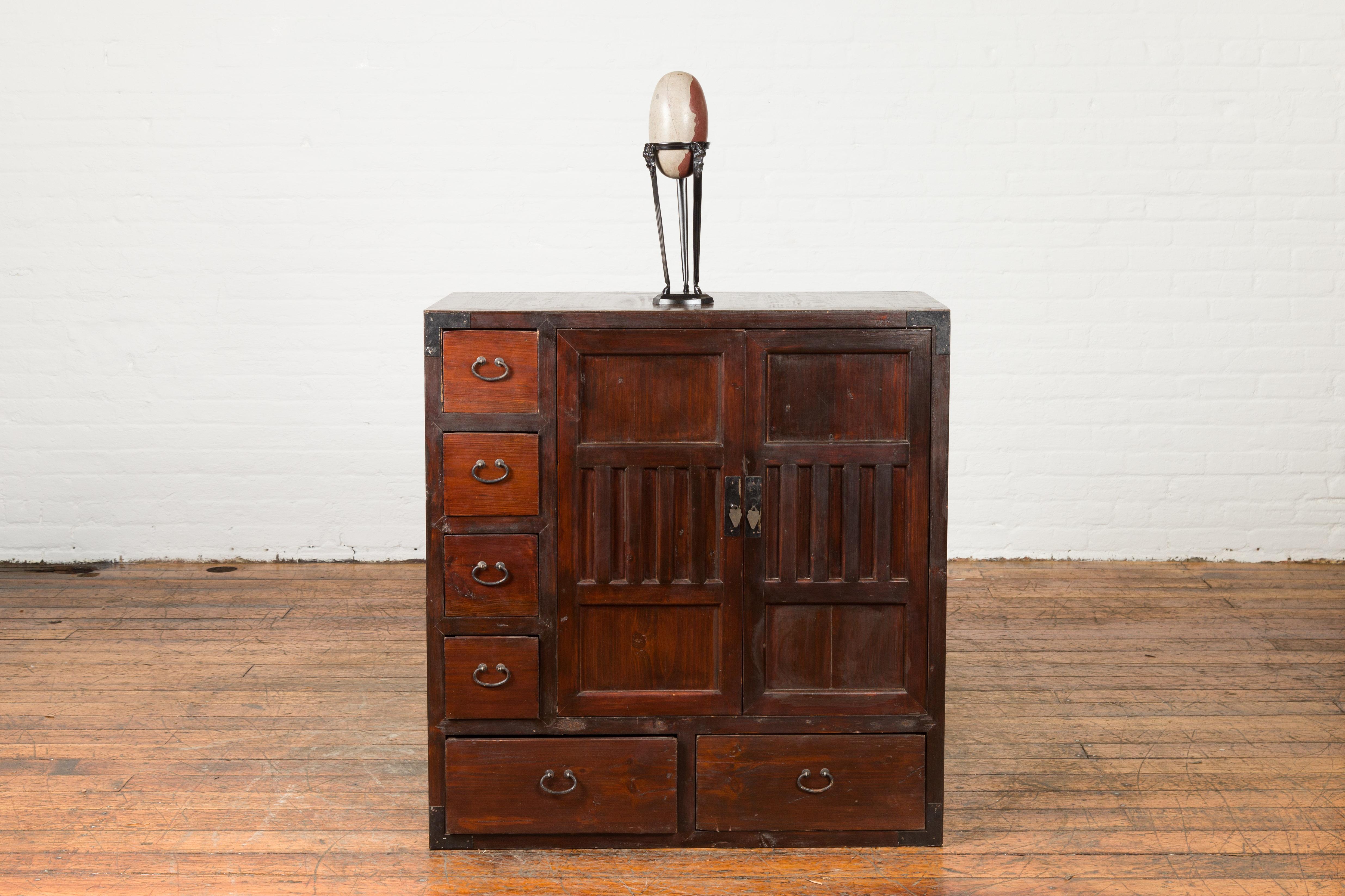 A Japanese antique two-way floating side cabinet from the early 20th century, with two doors and drawers. Created in Japan during the early years of the 20th century, this two-way floating cabinet features a rectangular top sitting above a pair of