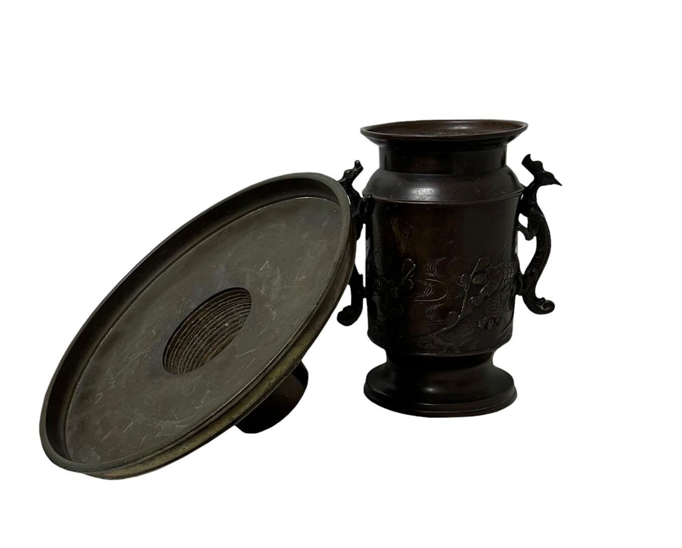 Japanese bronze usabata flower arranging vessel probably late 19th century bronze with a dark brown patina. The top is five and a half inches in diameter and comes off.