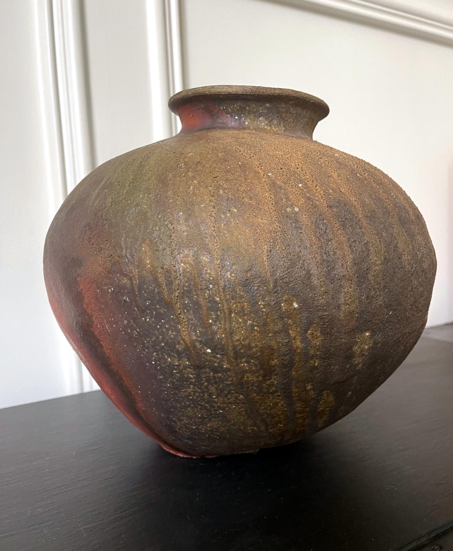 A Japanese storage jar (tsubo) made in the ancient Echizen ware tradition by Fujita Jurouemon VIII. Echizen is one of the six ancient kilns in Japan, directly influenced by the Sue ware of the Heian period. Echizen ware is fired without applied