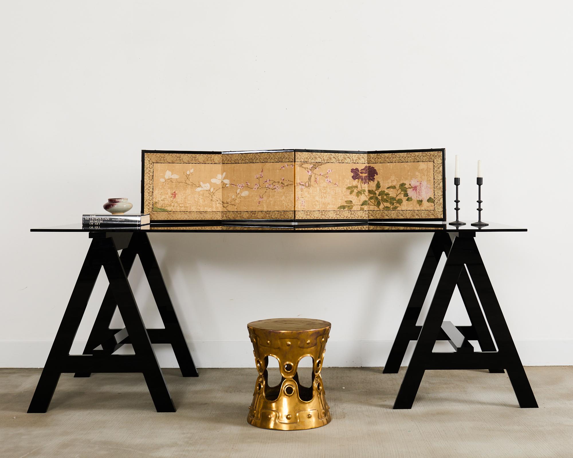 Early 19th century Japanese Edo/Tokugawa period four panel folding byobu table screen featuring peony, prunus, and magnolia. Painted with ink and natural color pigments on silk with an aged, distressed patina on the faded finish. Set in a later