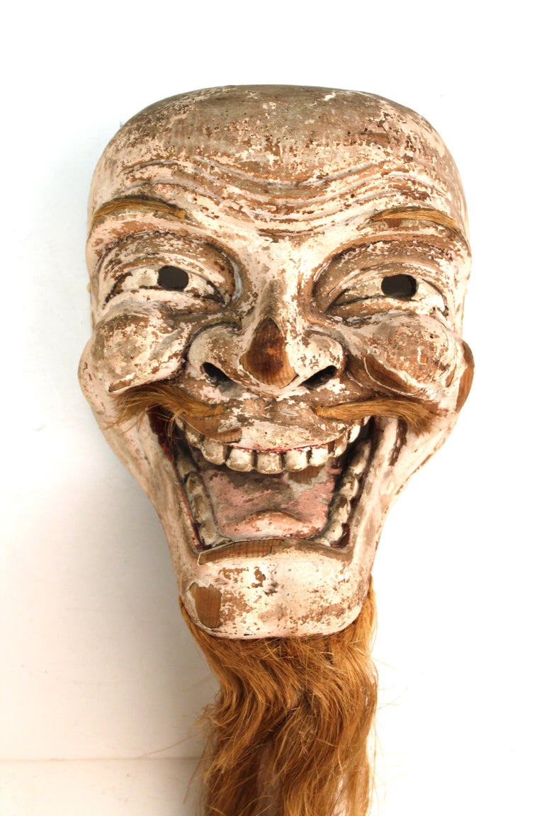 Japanese Edo period carved wood mask of a man with a golden hair beard. The piece shows a very expressive face and was likely made during the 19th century. Wear to the surface due to age and use, but overall in great antique condition.