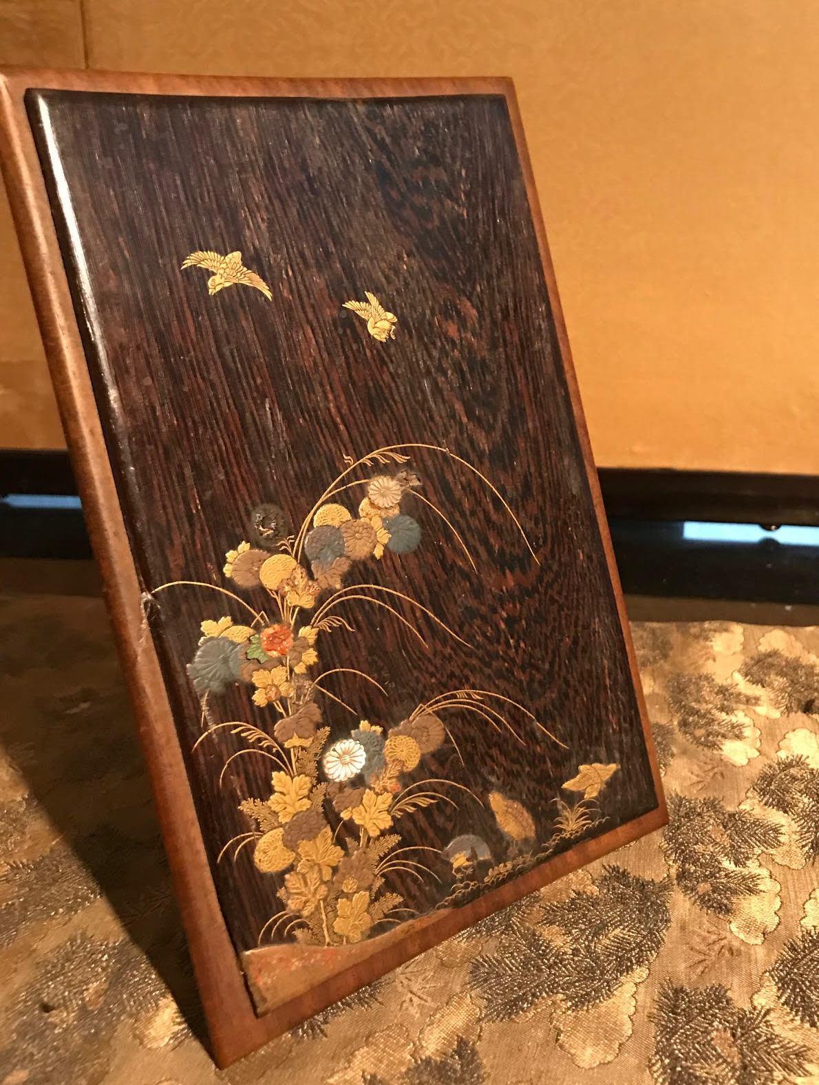 Japanese Edo period single panel table screen finely ornate with gold, mother of pearl and coral, lacquered. The scene depicts birds and flowers and is executed on Paloma wood, placed on a willow wood stand. From the Mary Burke Collection.
In great