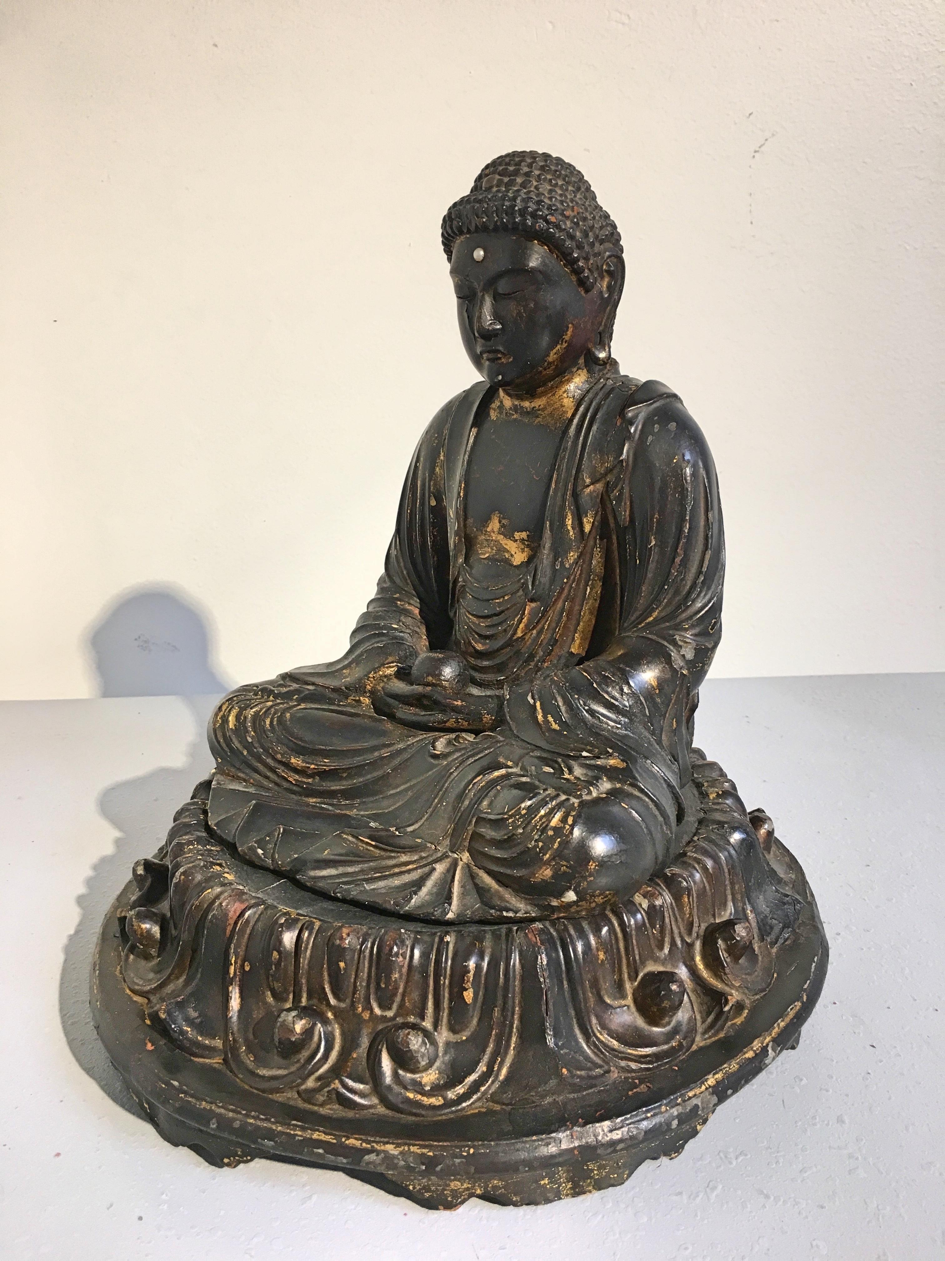 A fine and sensitively carved Japanese carved wood and lacquered Yakushi Nyorai, the Medicine Buddha, Edo period, late 18th or early 19th century.

The Buddha of Healing, Bhaisajyaguru, known as Yakushi Nyorai in Japan, is portrayed seated in