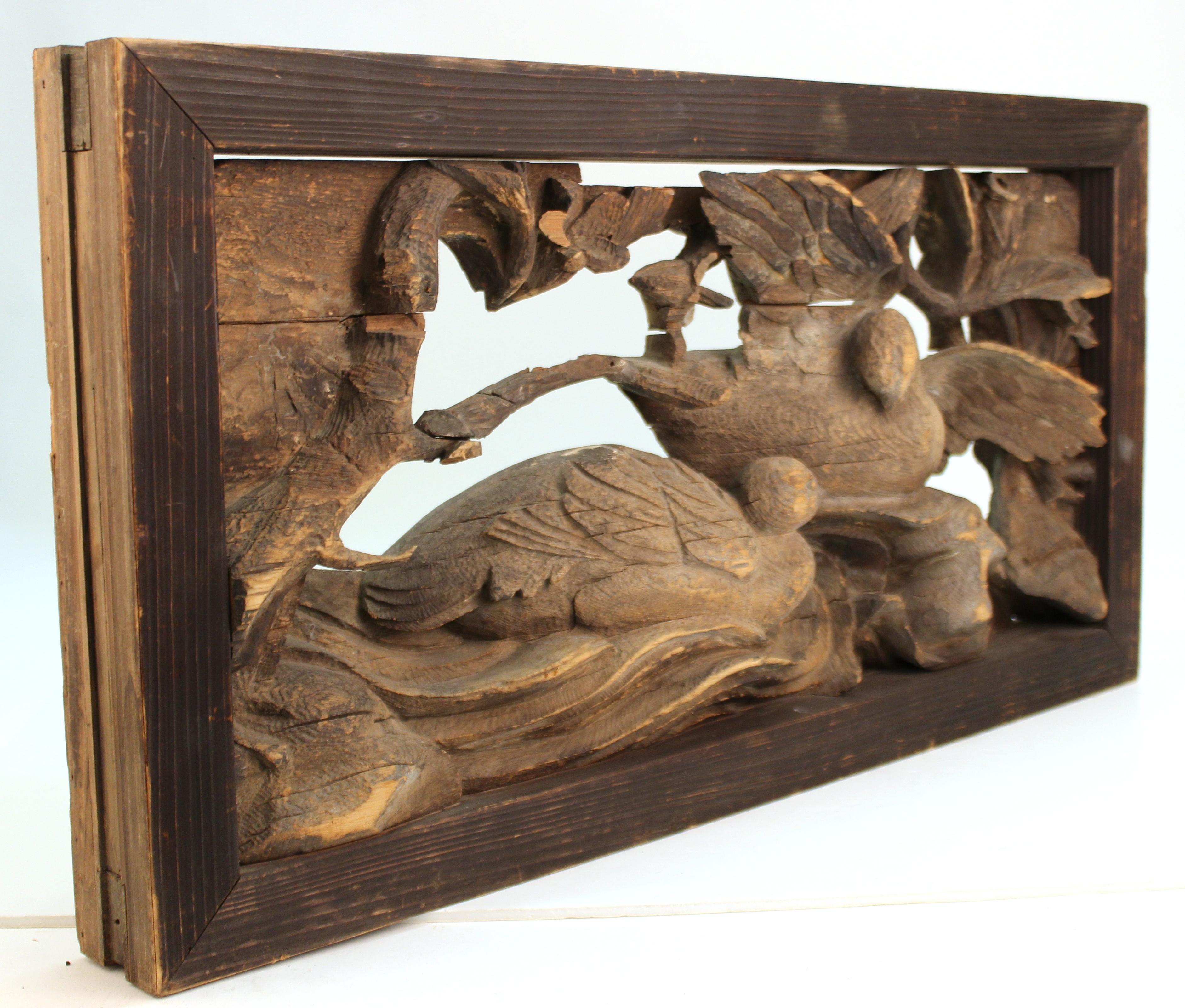Japanese Edo period wooden temple carving with two doves in branches. The scene is set into a frame that suggests the piece having been initially part of a building element or a furniture piece. Dates to the 17th century.