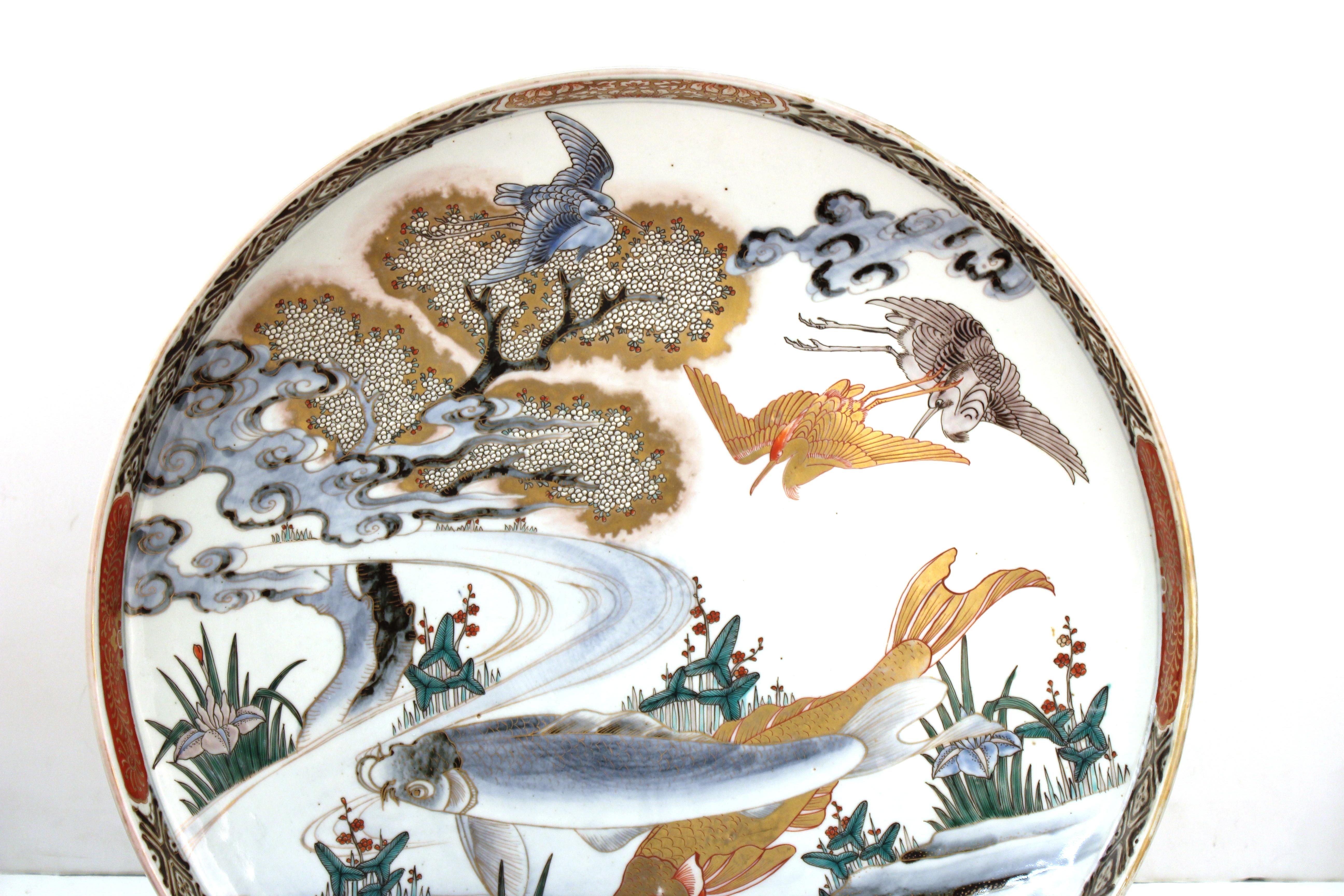 Japanese Meiji period large porcelain charger with fish theme and decorative border. The piece was likely made during the Meiji Period. In great antique condition with age-appropriate wear and use.