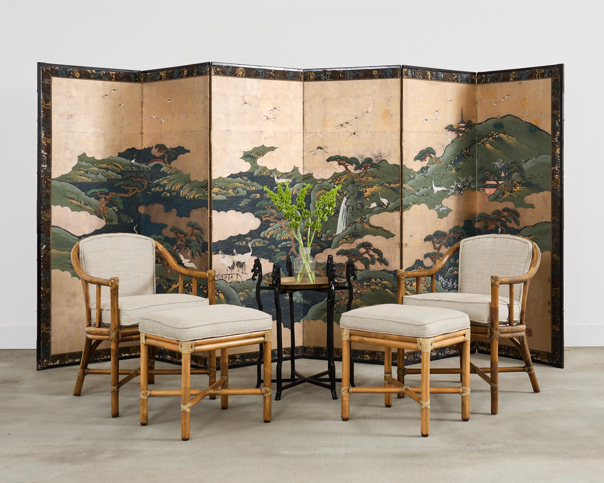 Fascinating 19th century Japanese Edo period six-panel byobu screen depicting the Isle of Immortals. The painting features white Manchurian cranes among pines and flowering plum centered by a dramatic waterfall. Ink and natural pigment colors over