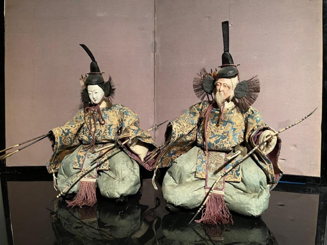 Japanese Edo period pair of shinto guardian Ningyo dolls from a Japanese Girls Day Festival, with carved wooden faces with layers of gofun oyster shell lacquer, dressed in sumptuous silk brocade and seated on altar stands. Made in Japan in circa