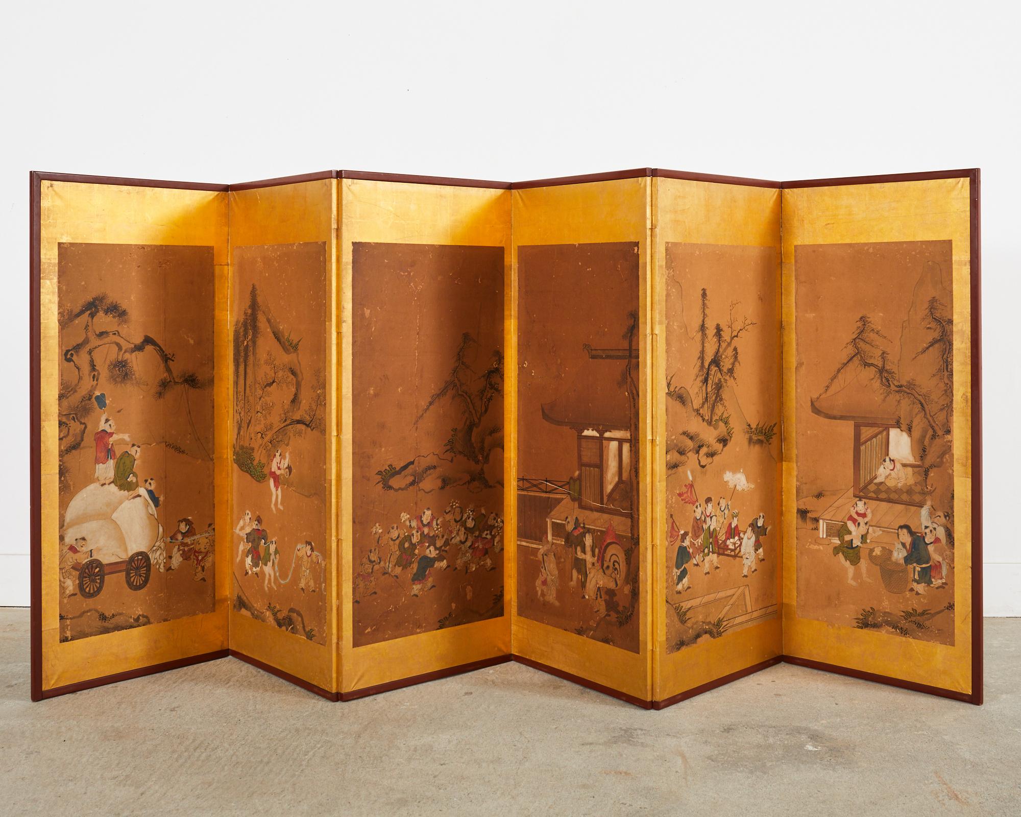 Amazing 19th century Japanese Edo period six panel folding byobu screen depicting Chinese children at play. The screen alludes to the 100 children theme. The paintings are set in a lacquer painted faded red frame with dramatic gold leaf borders. The