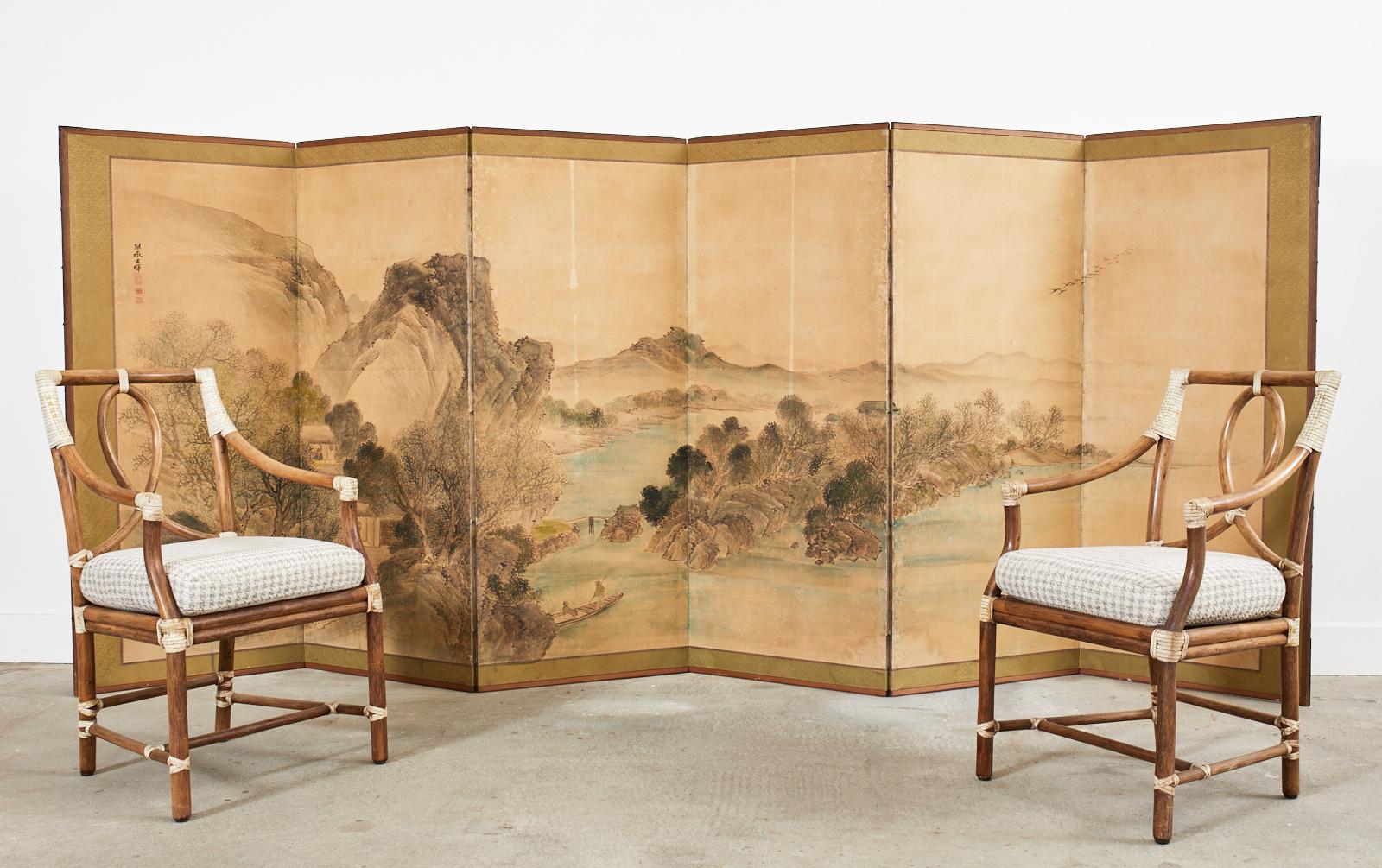 19th century Japanese late Edo period six-panel landscape screen painted in the Nanga/Literati school style by artist Oka Yugaki (Osaka, Japan died 1834). The large painting depicts a water landscape with rustic dwellings in the manner of Yosa
