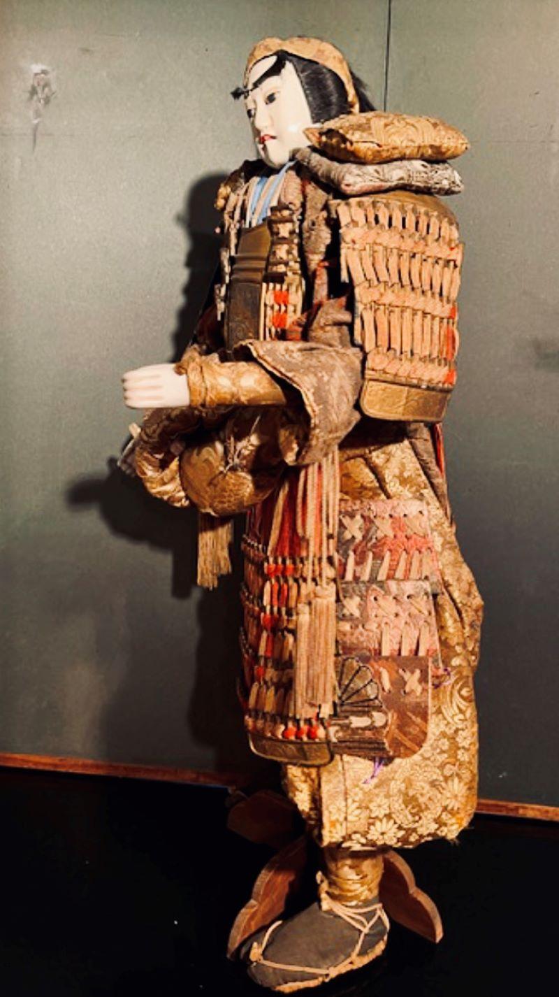 Bunraku (marionetta) raffigurante il guerriero Minamoto Yoshitsune, con la testa scolpita in legno e ricoperta da un raffinato gofun bianco con dettagli dipinti. Il volto ritrae un bel giovane con un meccanismo di attivazione che permette alle