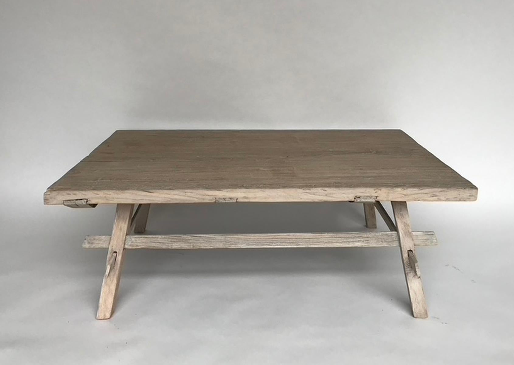 200 Year old, weathered Northern Japanese elm was used to make this rustic coffee table, featuring a base with stretchers. Naturally distressed wood throughout and lovely grayish/beige patina, like driftwood. Solid new construction.