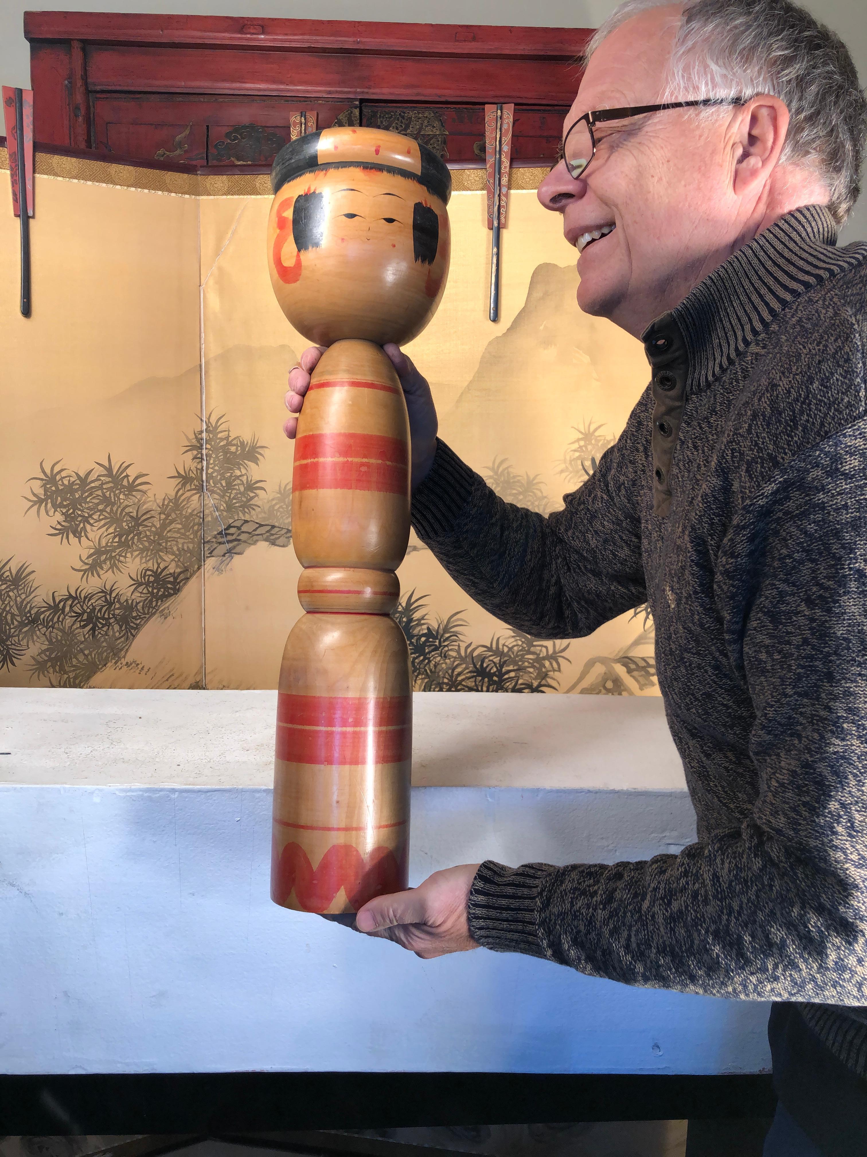Japan, an extraordinary example of a substantial 26 inch high one of a kind handcrafted and hand painted wooden Kokeshi doll, circa mid-20th century.

One of a kind collectible that rarely come onto the market in this massive size. Signed on