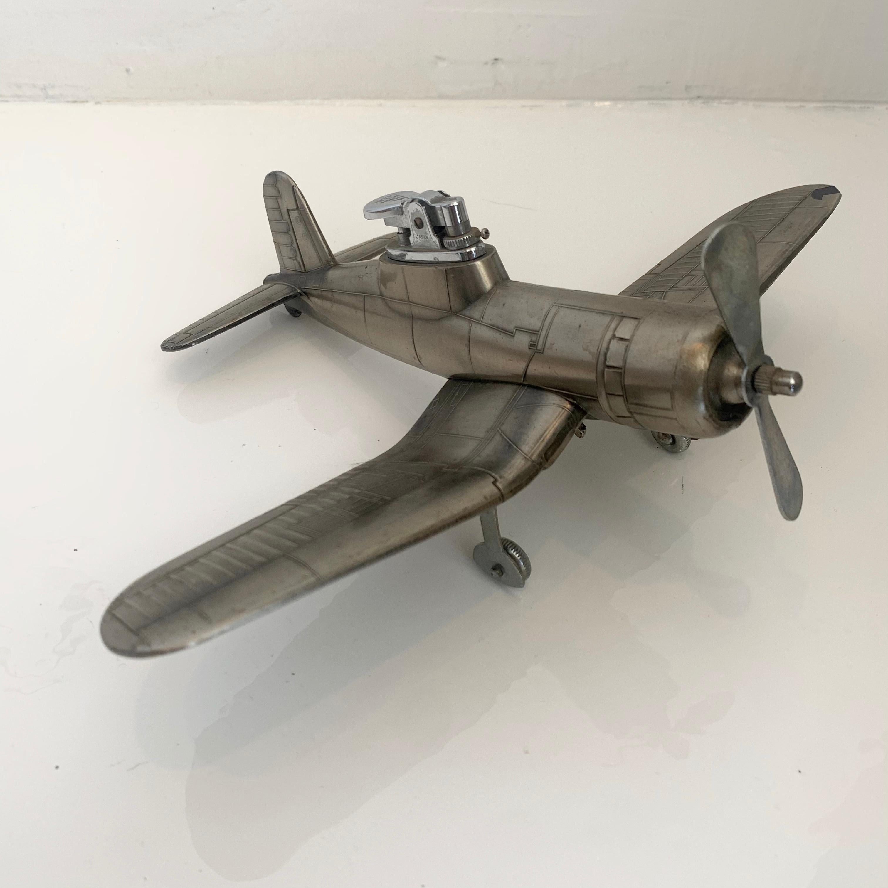 Cool vintage table lighter in the shape of a F4U-1 Corsair airplane. Made of metal with 