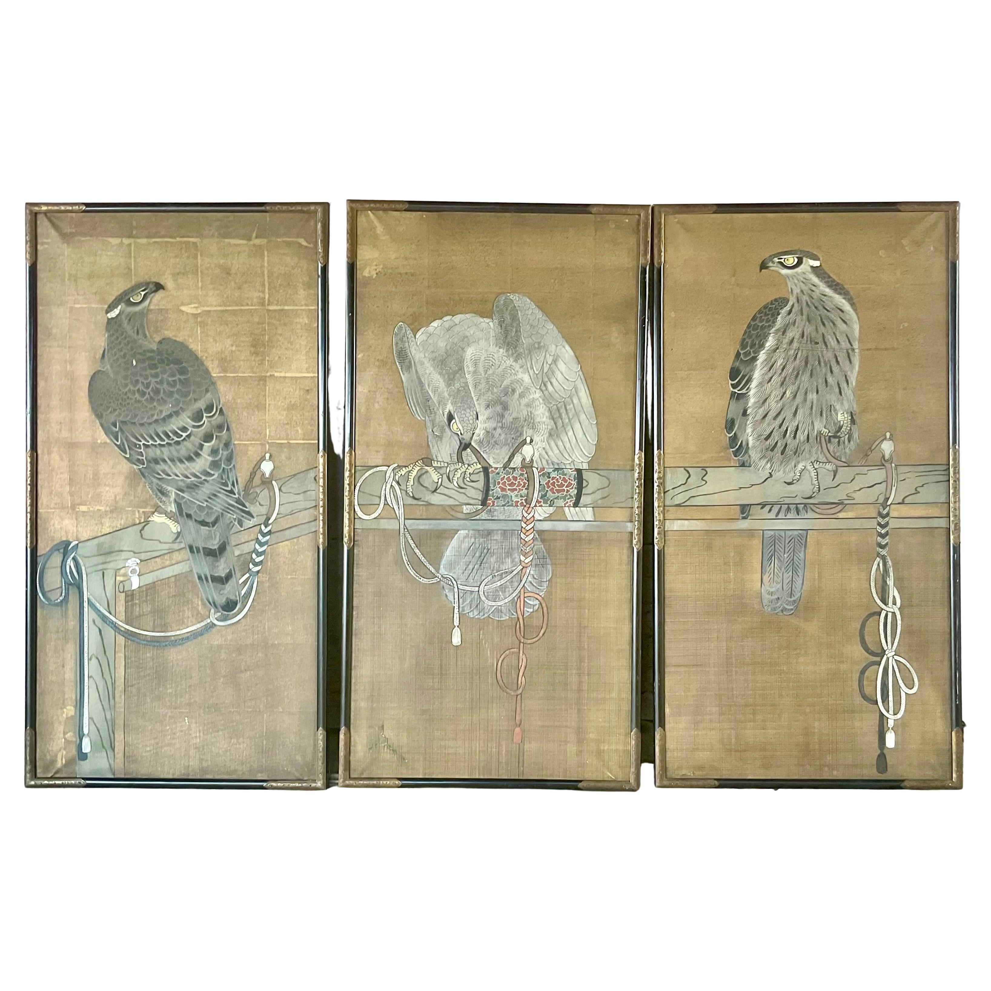 Set of Three Hand-Painted Japanese Watercolor Panels depicting falconry scenes, dating from the early 20th century. Each vertical panel features a meticulously rendered falcon perched on traditional wooden stands adorned with falconry cords and