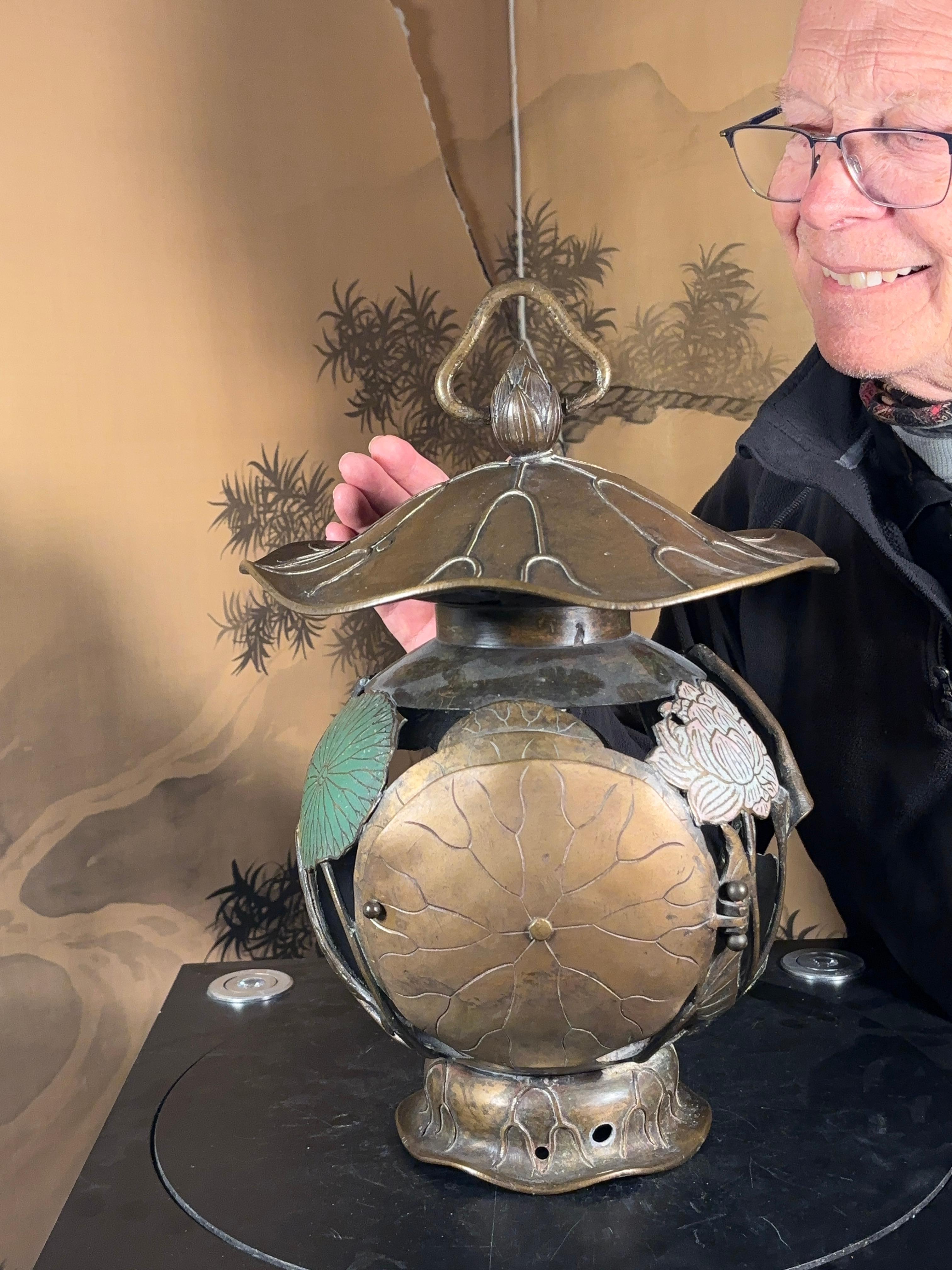 Hard to Find Lotus Lantern-  First we have seen

Please enjoy our video.

An innovative heavily hand cast, and extraordinary designed Lantern that could emit brilliant night light.  

Antique Japanese Hand Crafted  Bronze Hanging Lantern with unique