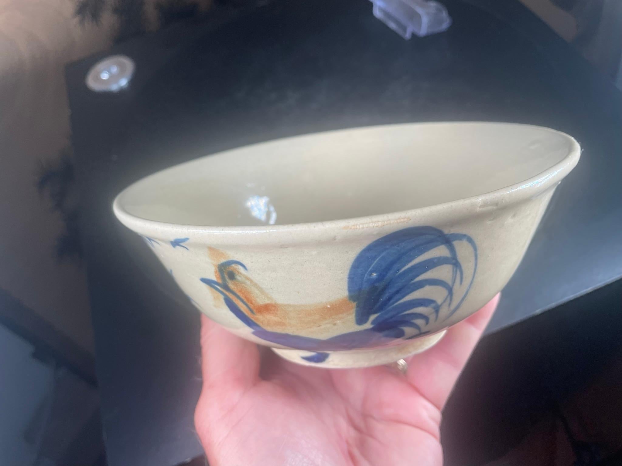 Mint Kyo ware bowl 

From Japan, a beautiful hand-built, painted and glazed, Kyo ware large bowl or large tea bowl with a proud rooster and birds motif created in the 1930s.- over seventy years ago.

A stunning medium blue and oatmeal clay.

Mint