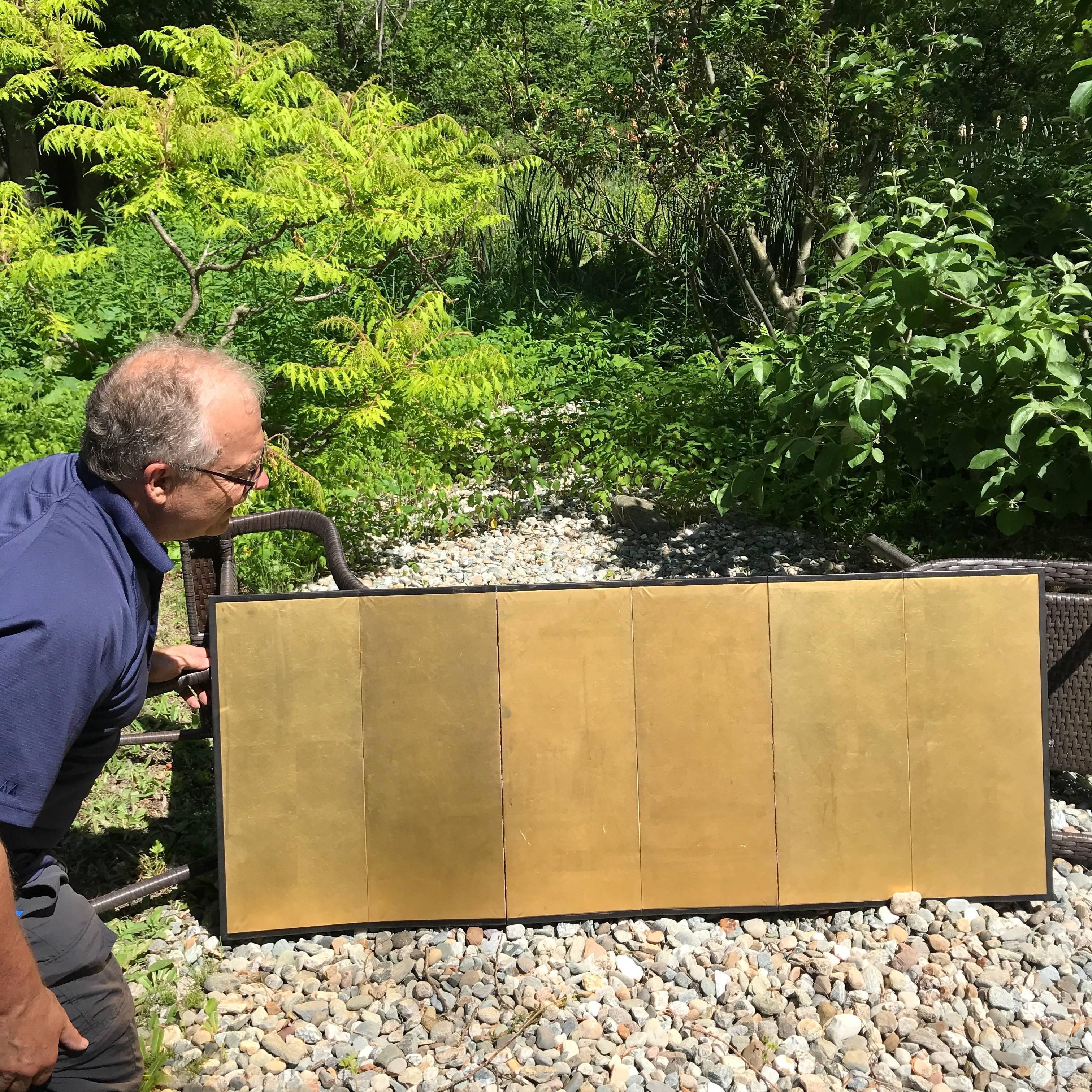 A fine pair of antique small-scale Japanese gold leaf six panel folding screens by obu conceived in a convenient size. These finely burnished examples feature a warm patina from gentle use and appropriately great age. 

Rich gold leaf applied to