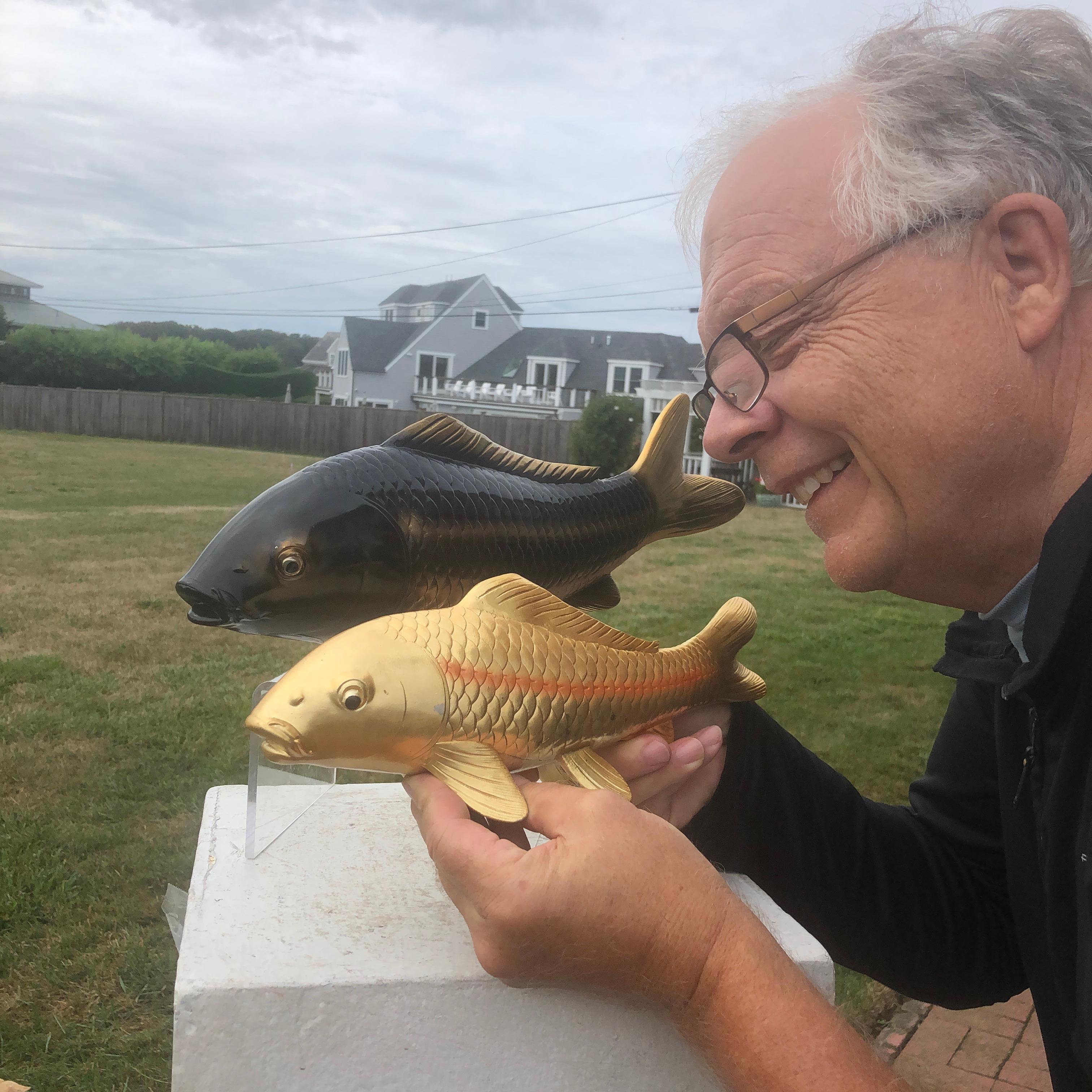 Signed and mint condition

Here's a rare find from a collector in Kyoto. A very unusual treasure from Japan. 

This is a finely crafted pair of bronze koi one in a realistic darker gray color and one in light gold color.

Both signed on