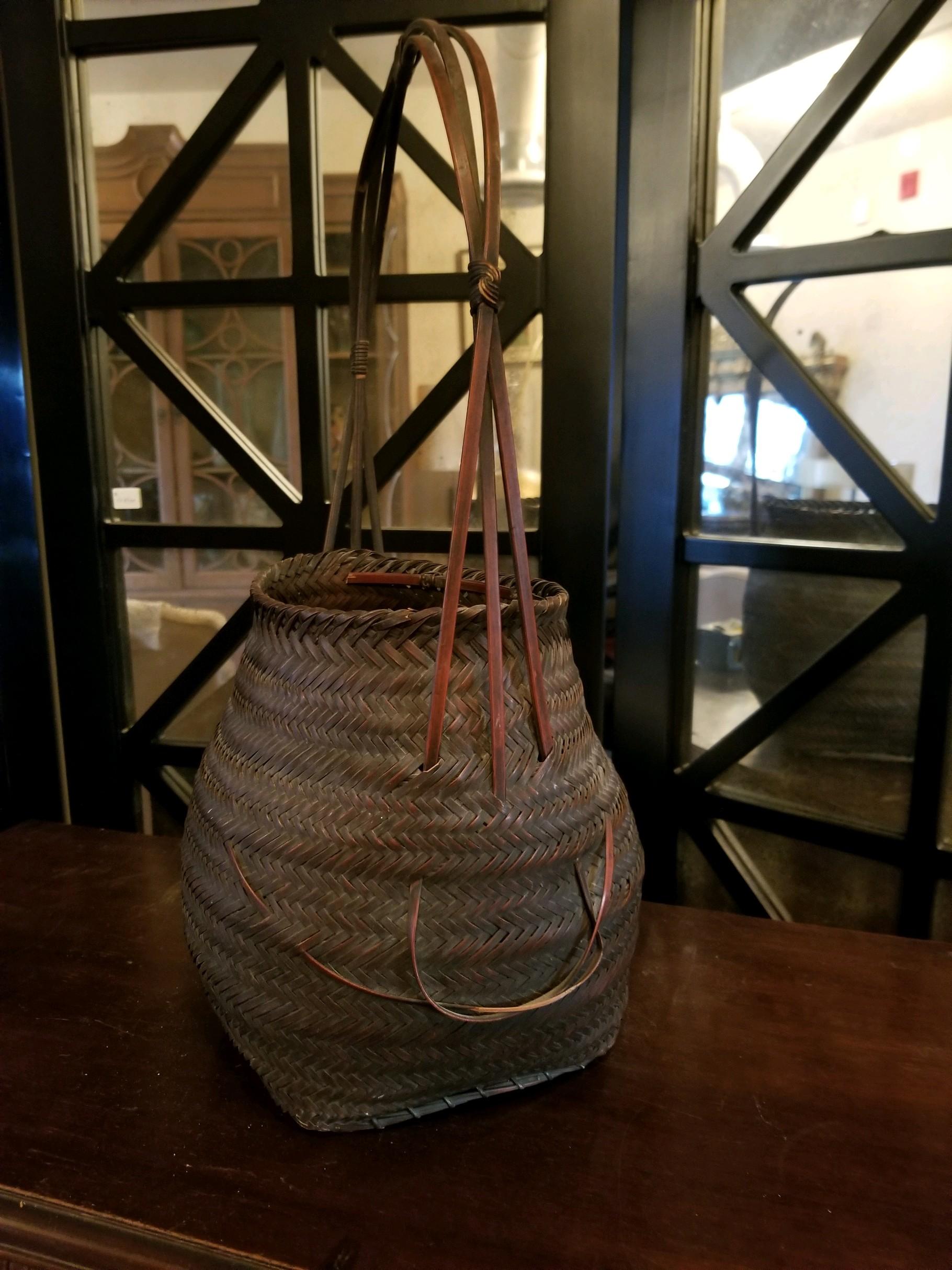 This Japanese flower arranger container is beautifully woven in fine threaded material. This is simplicity at its finest. Japanese sophistication with slight decoration across front with integrated handle. Turn of the century and in good condition.