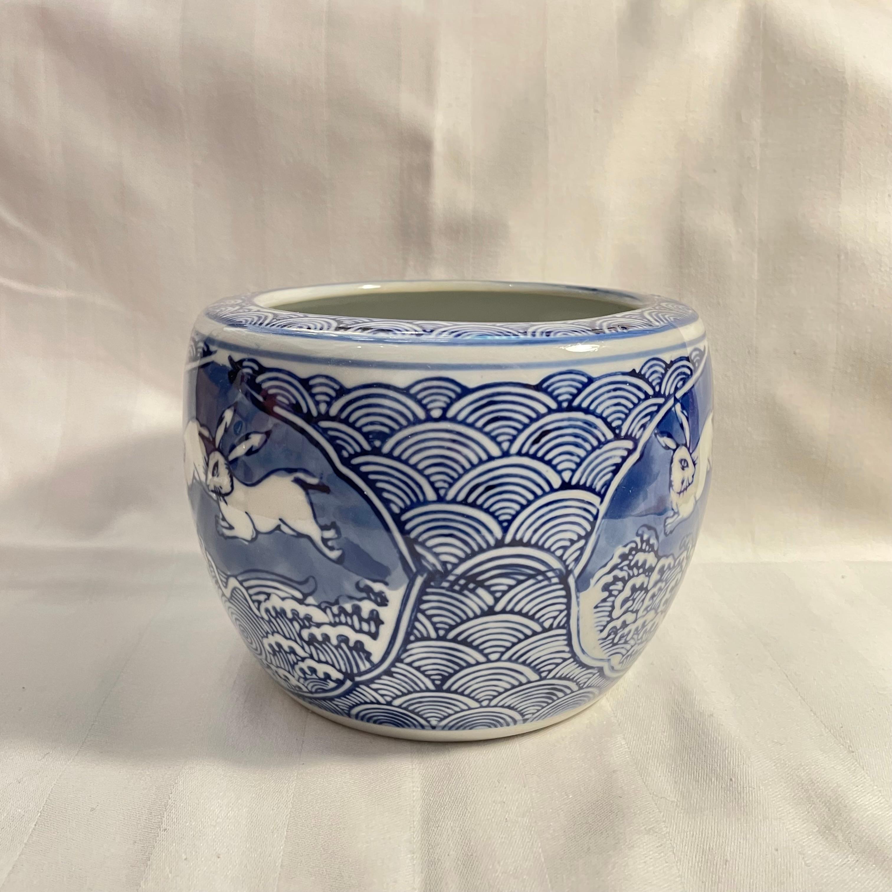 This flower pot was made in Japan around 1990s. It is made with porcelaine.
The motif of this pot is called 'Choju Giga' which is oldest manga in Japan.

Chōjū-jinbutsu-giga, commonly shortened to Chōjū-giga, is a famous set of four picture scrolls,