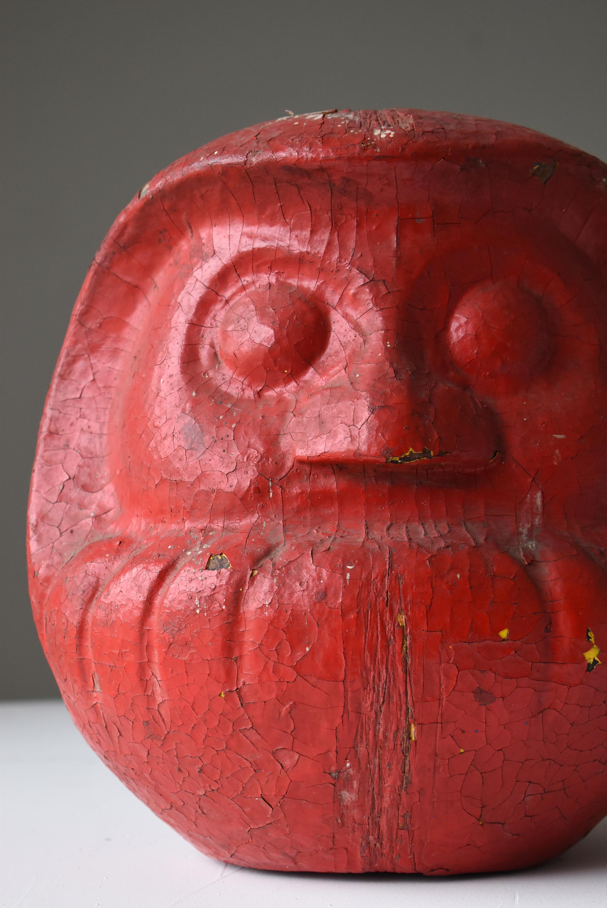 It is an old Japanese Daruma doll.
In Japan, Daruma dolls are generally painted in red. Red, the color of fire and blood, has long been believed to have an amulet effect.

There are many wood carvings, but this is pottery.
The whole is painted