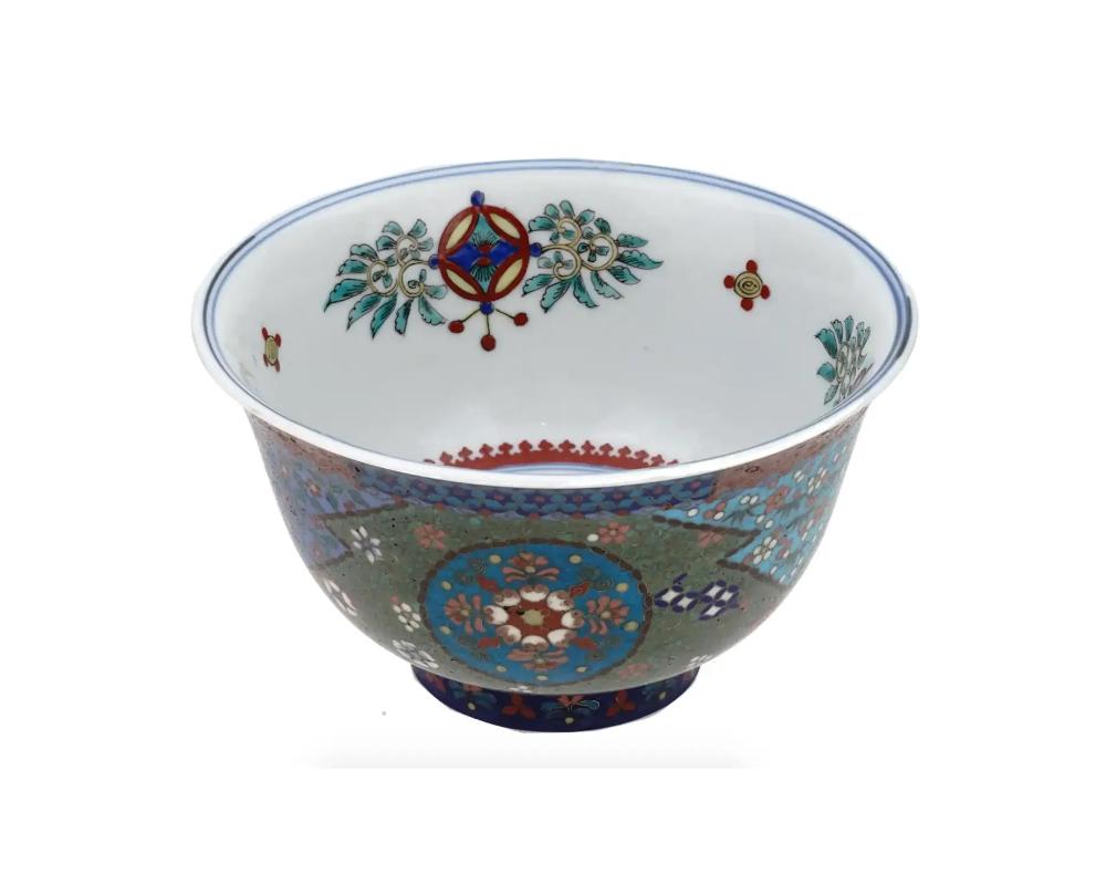 Antique Early Meiji Japanese Cloisonne Enamel Footed Porcelain Bowl Totai
An antique Japanese Meiji era footed enamel over porcelain bowl. The exterior of the bowl is enameled with polychrome floral, foliage and swirl motifs made in the Cloisonne