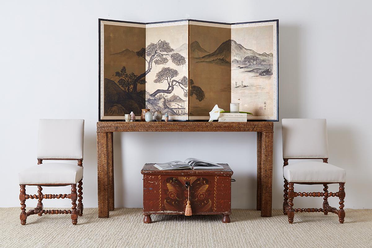 Hand painted Japanese four-panel byobu screen depicting a mountain and lake landscape. Painted on gilt squares with a large pine tree over a pagoda on one side and fishing boats on the other side. Signed and sealed on the right side and set in a