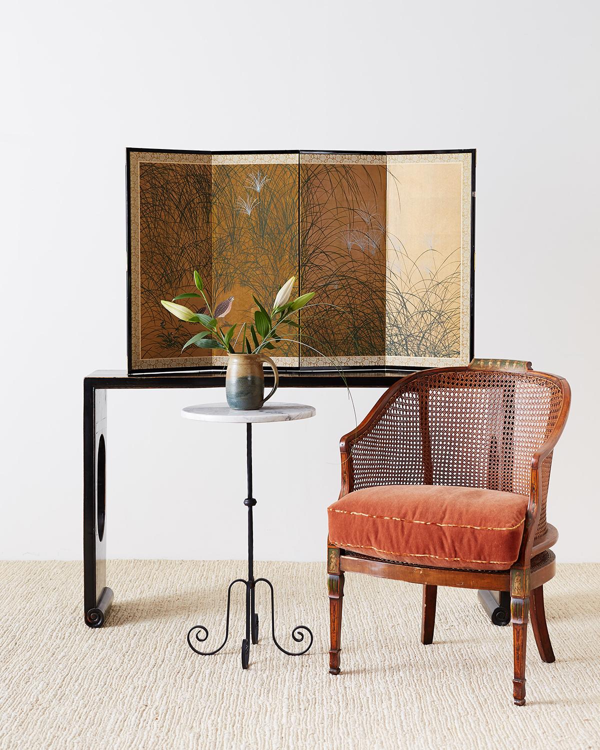 Charming Japanese four-panel byobu screen depicting two young quail in Eulalia grasses. Beautifully painted with fine grass and flowers over squares of gold leaf. The screen is set in an ebonized wood frame with a gold silk brocade border.