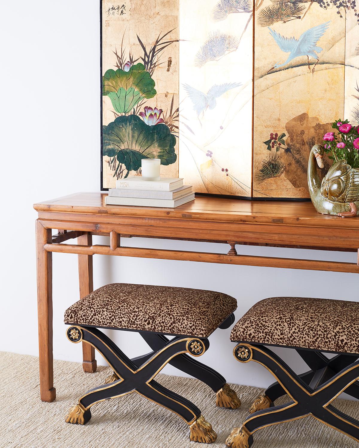 Spectacular Japanese four-panel byobu screen featuring squares of gold leaf hand painted with white cranes. The screen is decorated with large green lotus blossoms amid pines and flowering vines. Executed with a thick paint finish over a textured