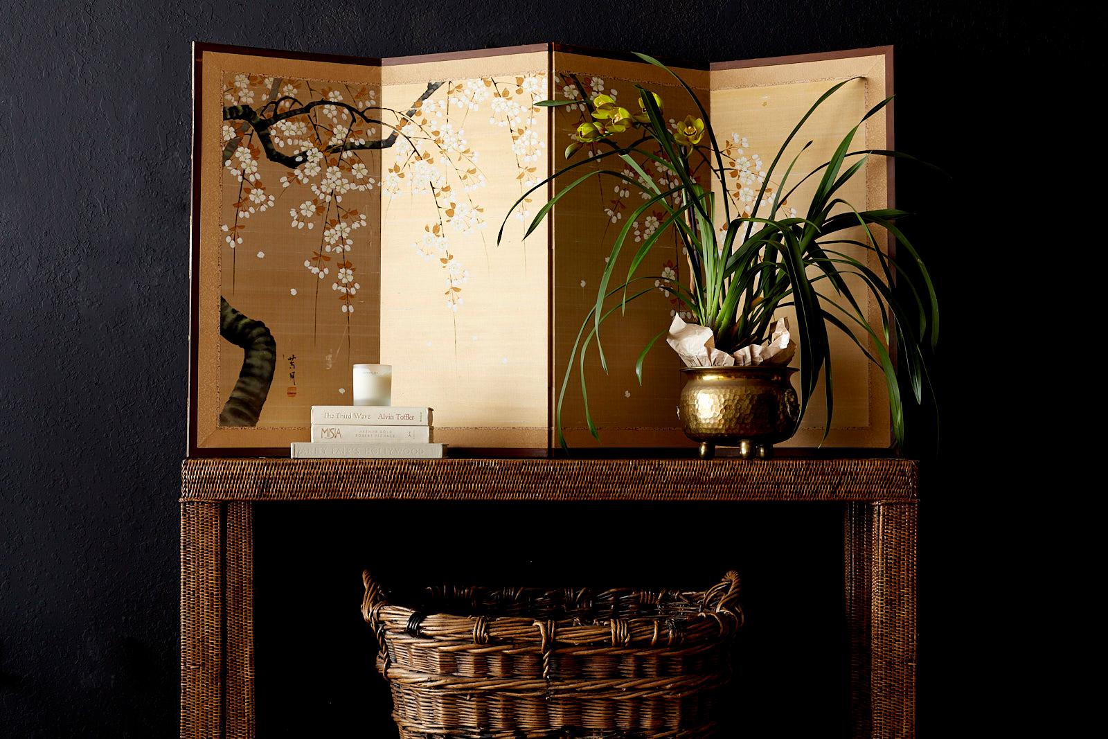 Wonderful Japanese four-panel byobu screen depicting a large prunus or Sakura cherry blossom branch in bloom. Hand painted on a gilt silk ground with a fine textured finish. Set in a wooden frame with a golden silk brocade border. From an estate in