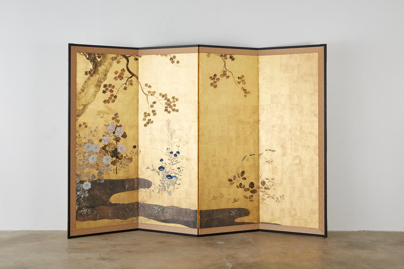 Magnificent Japanese four-panel 19th century Meiji screen. Made in the Rimpa School style depicting a serene floral autumn landscape. Beautifully painted sumi ink and color pigments over gold and silver leaf squares. Delicate flowers of