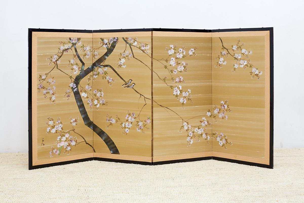 Delightful Japanese four-panel Byobu screen of spring cherry blossoms on silk. Features a raw style of textured silk background with a gilt finish. The painted cherry blossoms stand out against a contrasting gold field with two small birds in the