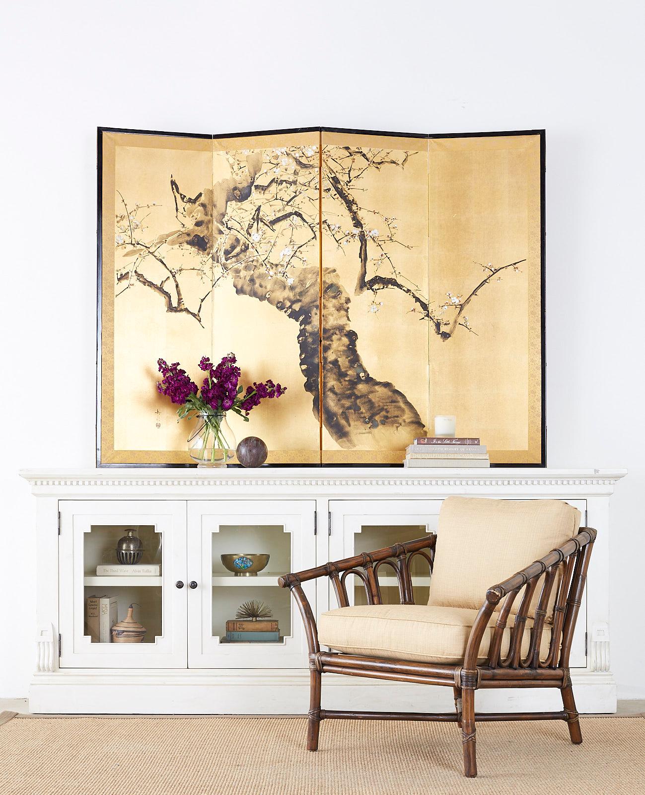 Impressive Japanese four panel screen depicting ancient flowering prunus tree with spring blossoms. Painted with ink and color pigments over gilt squares in the Nihonga school style. Signed by artist Gakusui with a seal on left side. Set in a