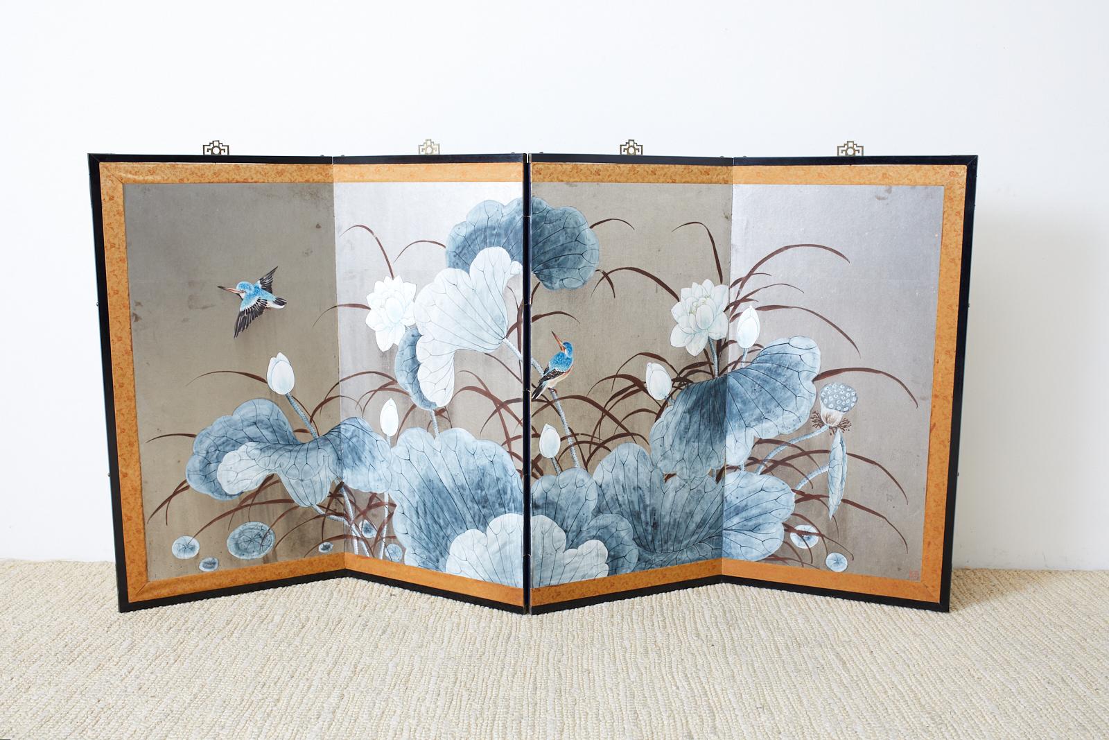 Stunning Japanese Showa period four-panel screen depicting large blossoming lotus leaves and kingfishers over a dramatic silver leaf ground. The screen is set in a lacquered wood frame with a brocade silk border and etched brass hardware. From an
