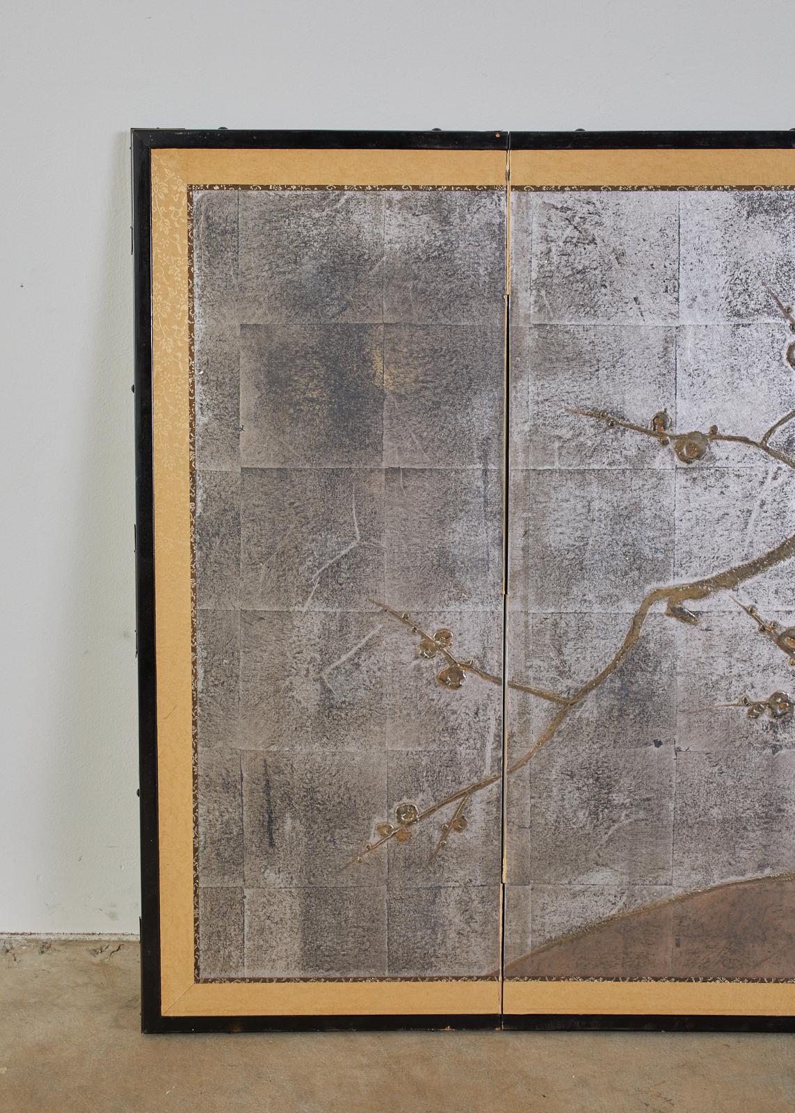 Unique Japanese four-panel folding byobu screen featuring a flowering prunus or plum tree over a dramatic silver leaf ground. The silver has a lovely faded patina that gives a moodiness to the art work which is painted in a moriage or raised pigment