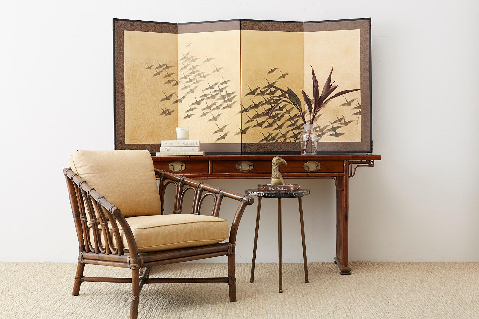 Modern style Japanese four-panel screen depicting a large flock of wild geese in flight. The geese are flying over a stylized rendition of waves. Made in the Nihonga school style, ink on handmade textured paper that sparkles when viewed in direct