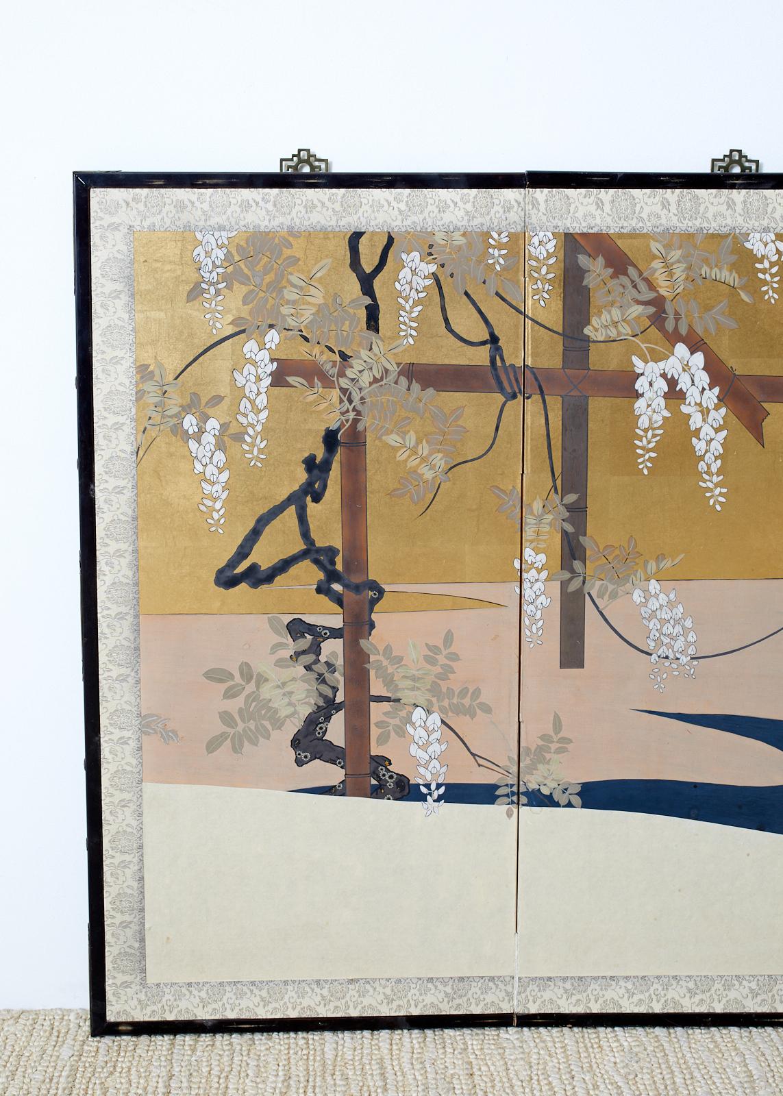 Delightful Japanese Showa period four-panel screen depicting a spring landscape with a trellis supporting wisteria and iris blooms. Beautifully crafted with large areas of gilt squares and deep indigo blue. Harmonious textures and colors that must