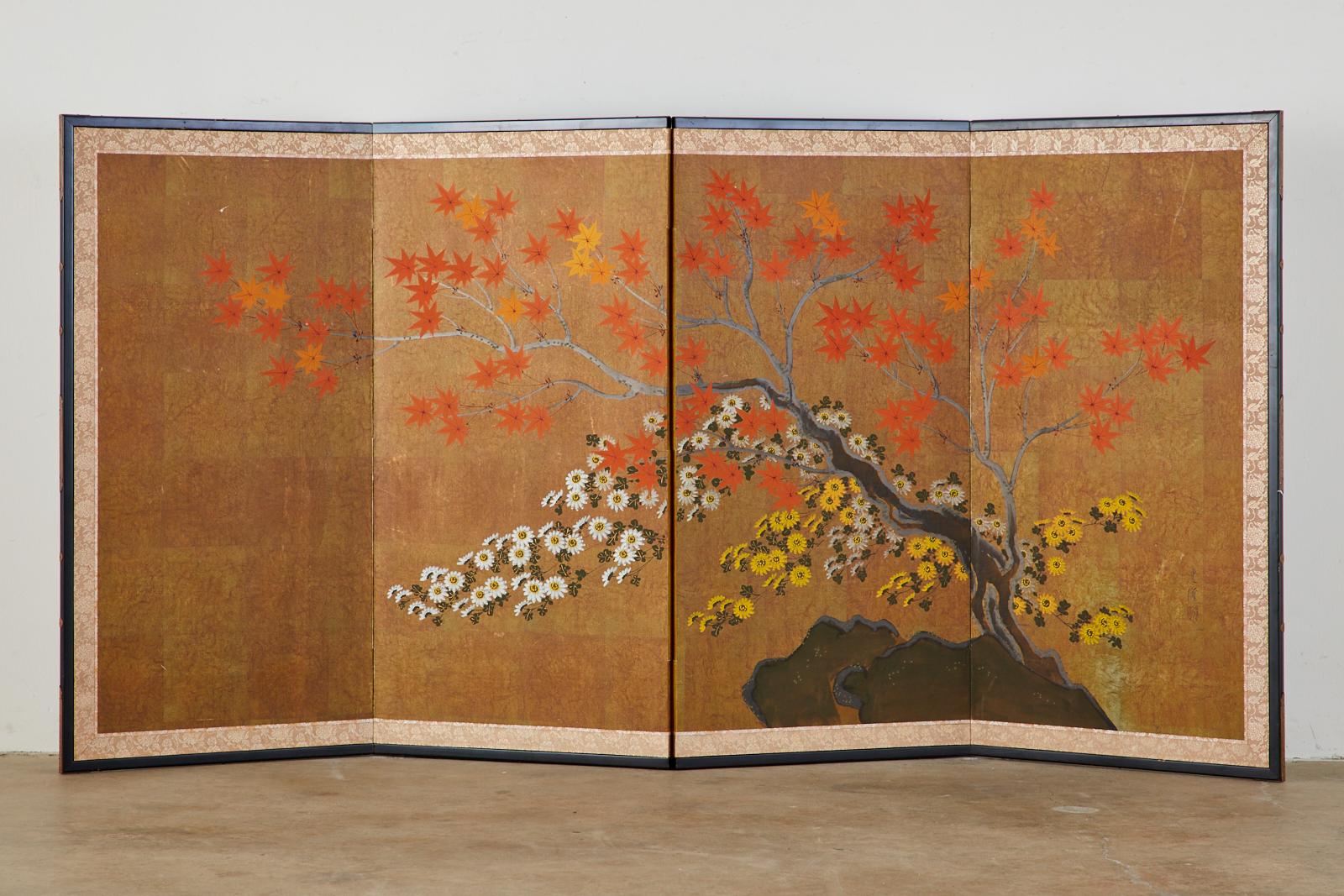 Colorful Japanese four-panel Showa period screen depicting a Japanese maple (Momiji) and flowering Chrysanthemums in autumn, ink and color pigments on gold paper. Made in the Nihonga School style. Set in an ebonized wood frame with a silk brocade