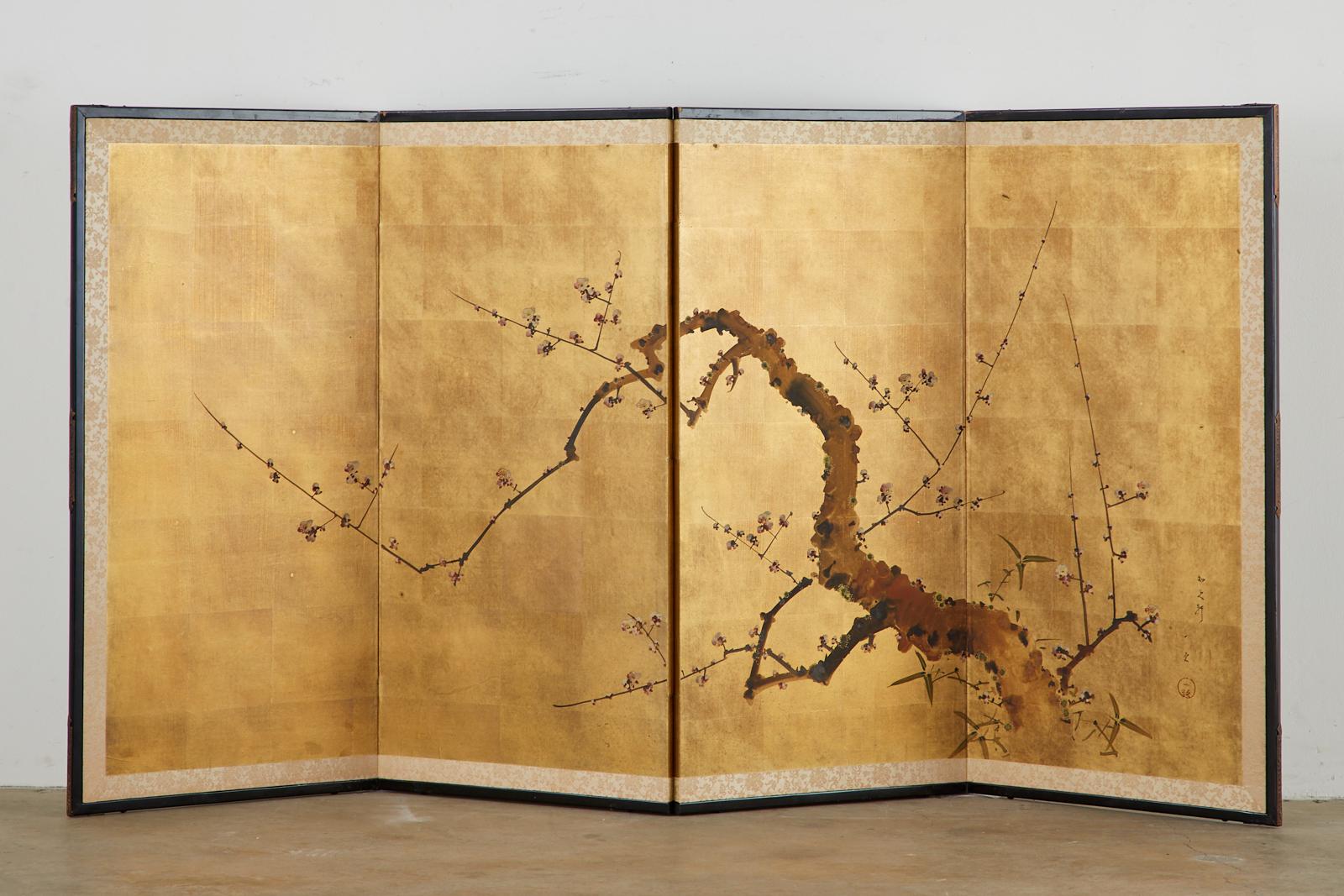 Showa period Japanese four-panel screen depicting a flowering prunus or plum tree in the spring. Ink and color pigments over gilt squares. Set in an ebonized wood frame with a silk brocade border. Signed and sealed on the right side. Made in the