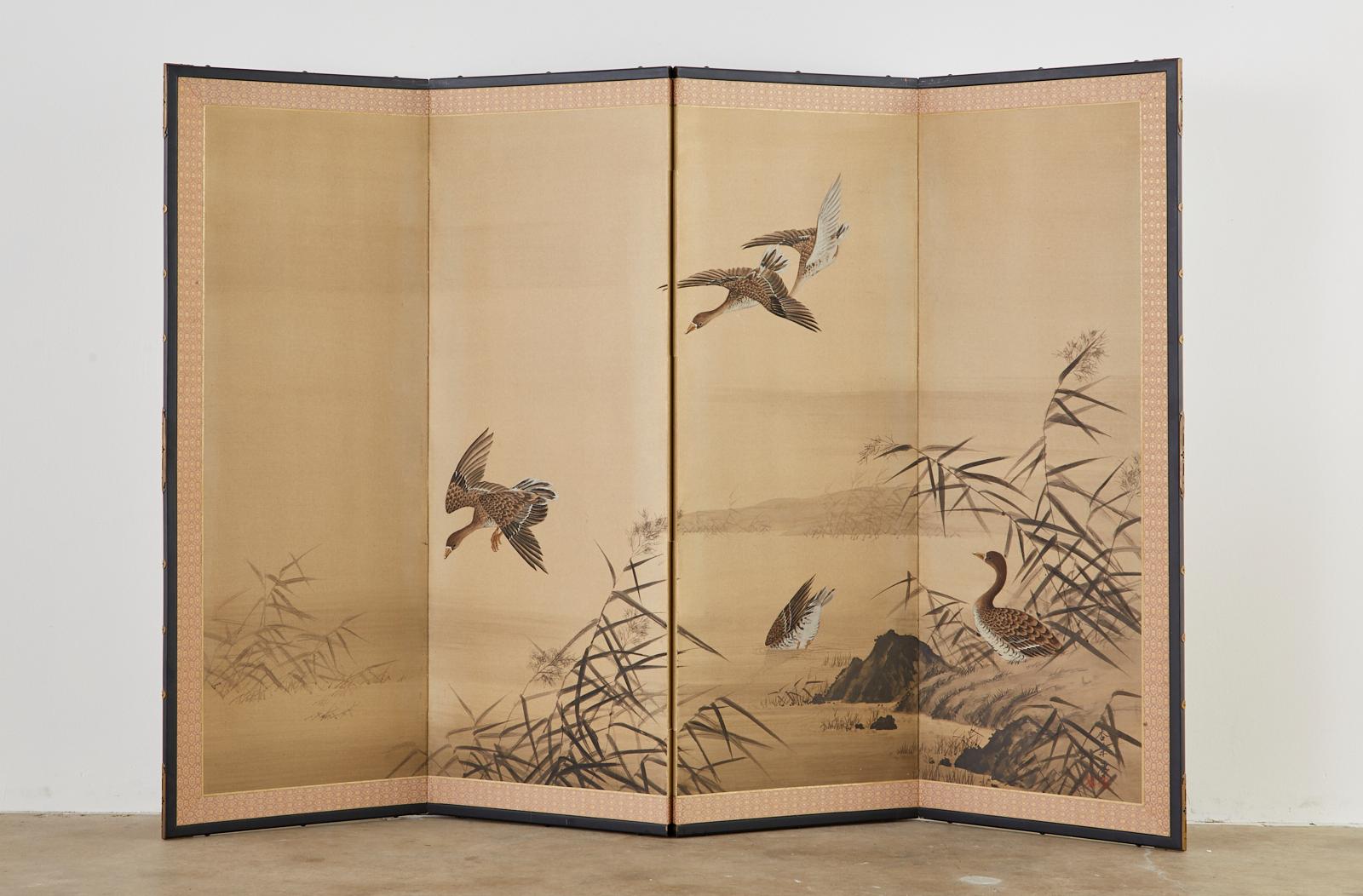 Fine Japanese four-panel Showa period screen depicting five wild ducks among reeds at a serene water landscape. Beautifully detained ink and color painting on gilt paper. Made in the Nihonga School style. Signed by artist with a seal Kyoka-hitsu on