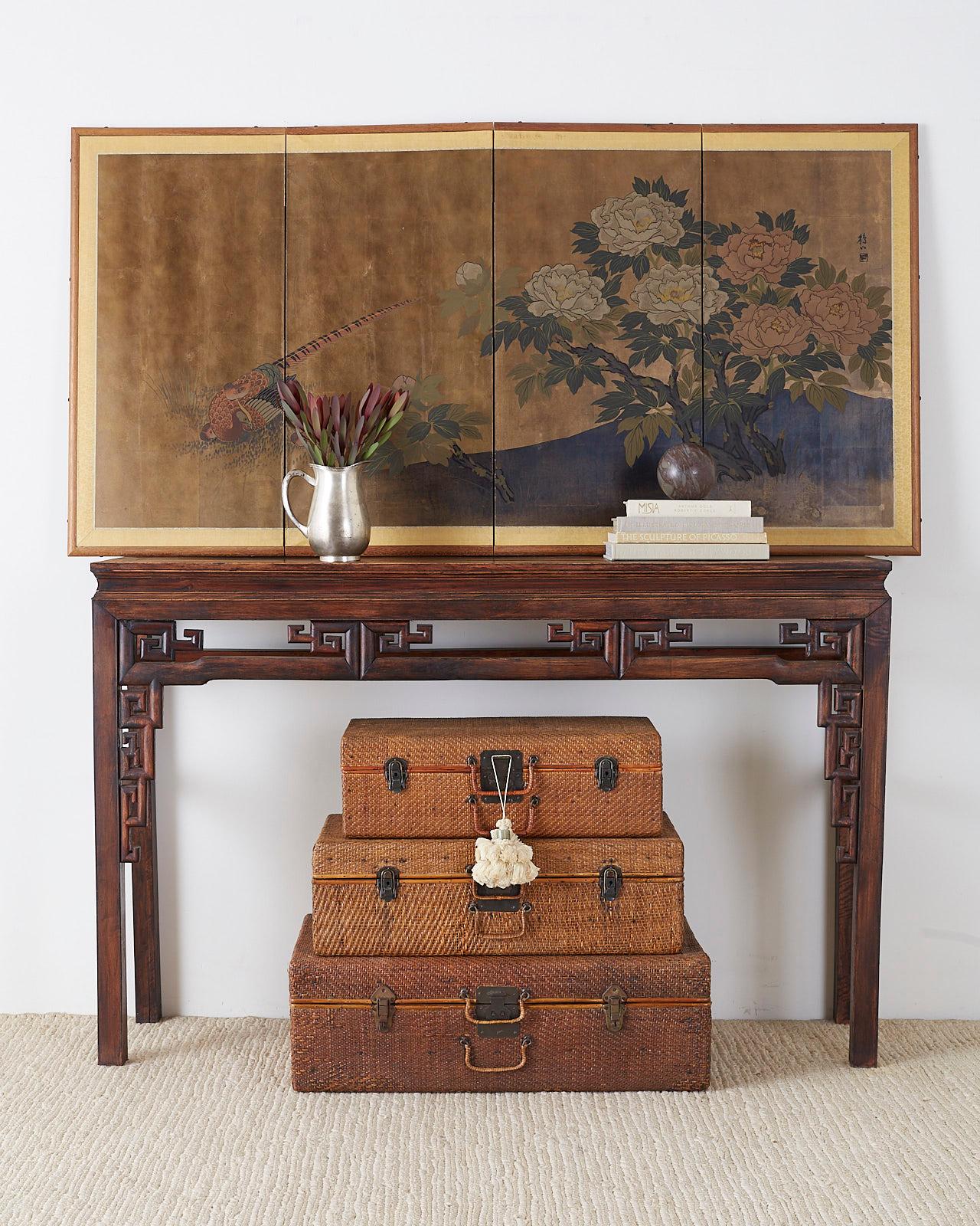 Charming Japanese Showa period four-panel screen depicting a pheasant and her chicks next to blooms of colorful red and white peonies. Ink and color pigments on printed paper with gilt squares. The painting has a rich faded patina with an artist