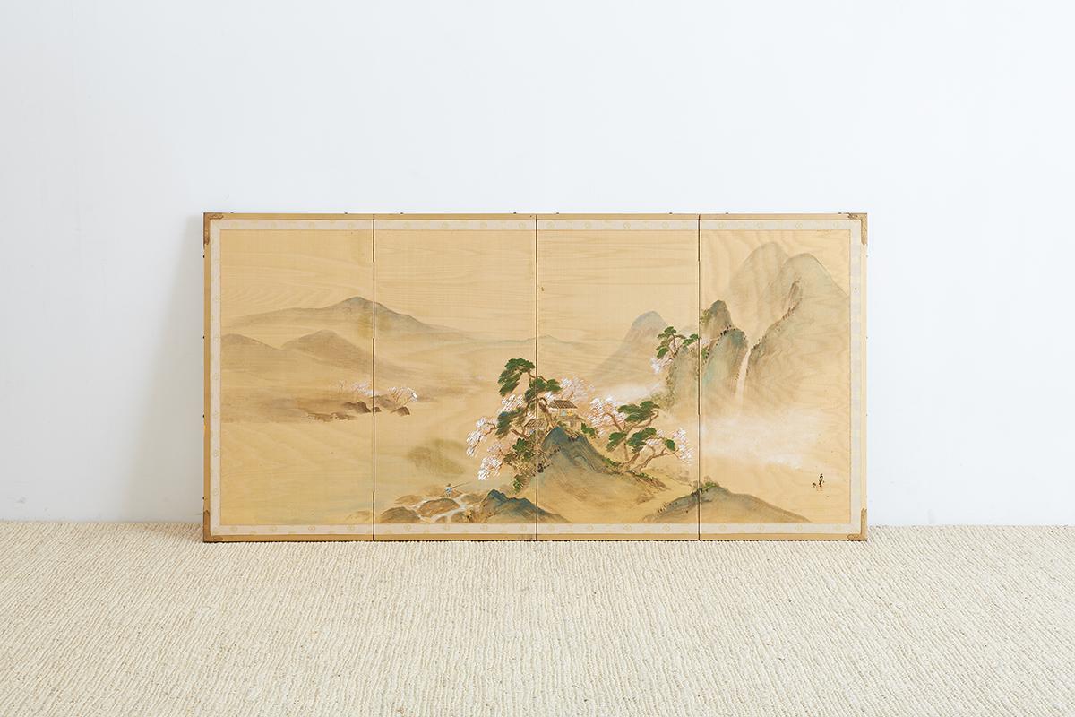 Exceptional Japanese four-panel Byobu screen of a mountain landscape painted on silk. The background features mountains and waterfalls with a small treed village in the center. The silk has a delicate water silk texture that adds another dimension.
