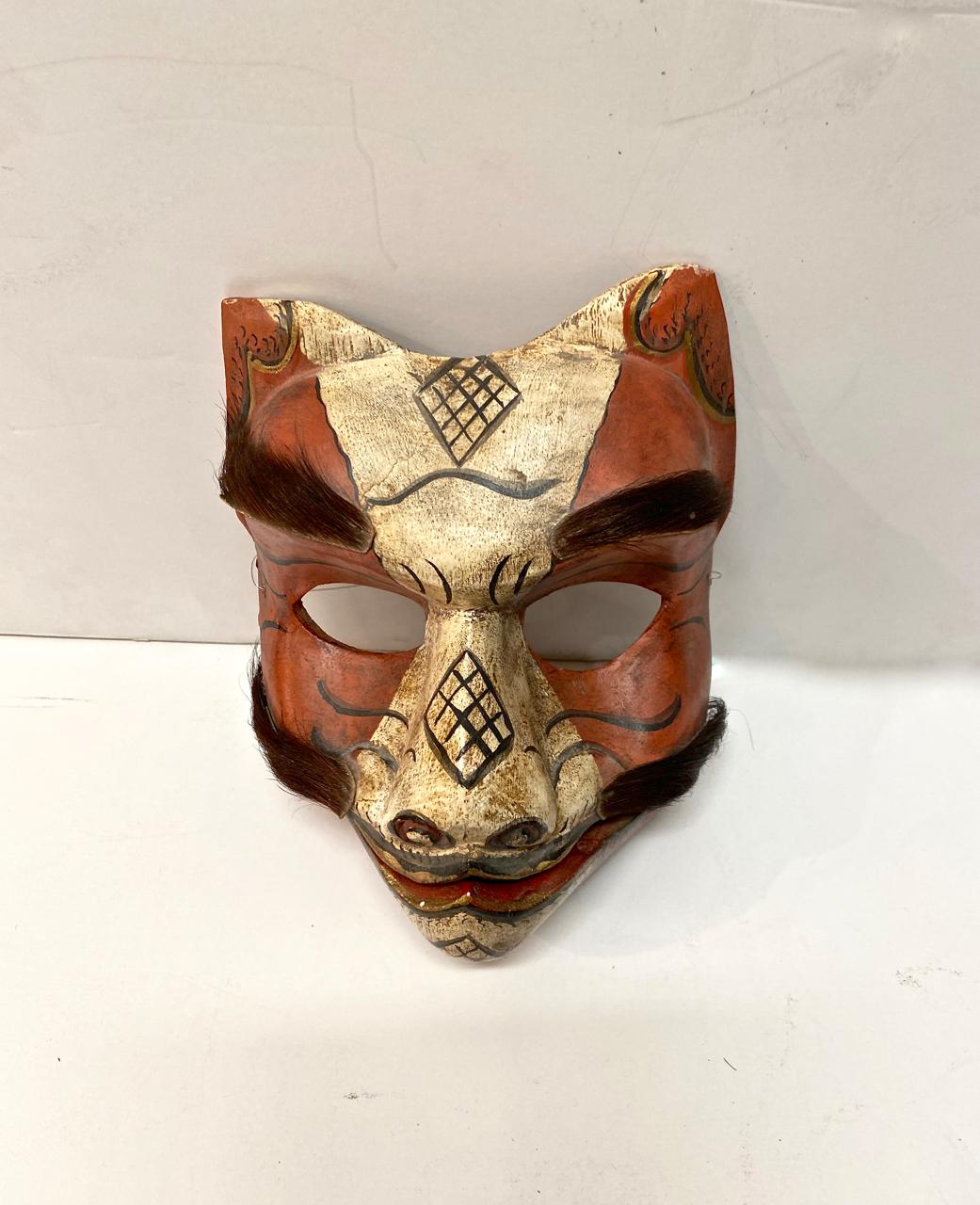 This is a wonderfully expressive and articulated fox mask. The mask dates to the first half of the 20th century and is in overall good condition. The fox's jaw is articulated and he is decorated with real fur for his eyebrows and mustache. In Japan