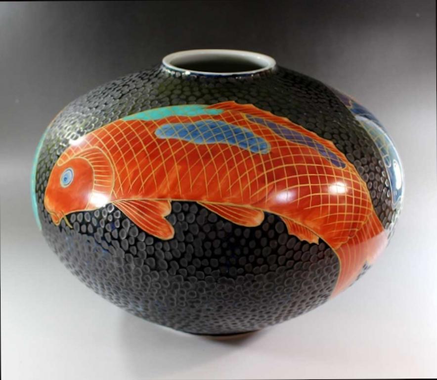 Exquisite contemporary Japanese large dimpled porcelain vase, hand-painted to showcase elegant koi or carp in vivid red, turquoise and blue, and intricate gold details, swimming against a dimpled black background, a signed piece from the signature