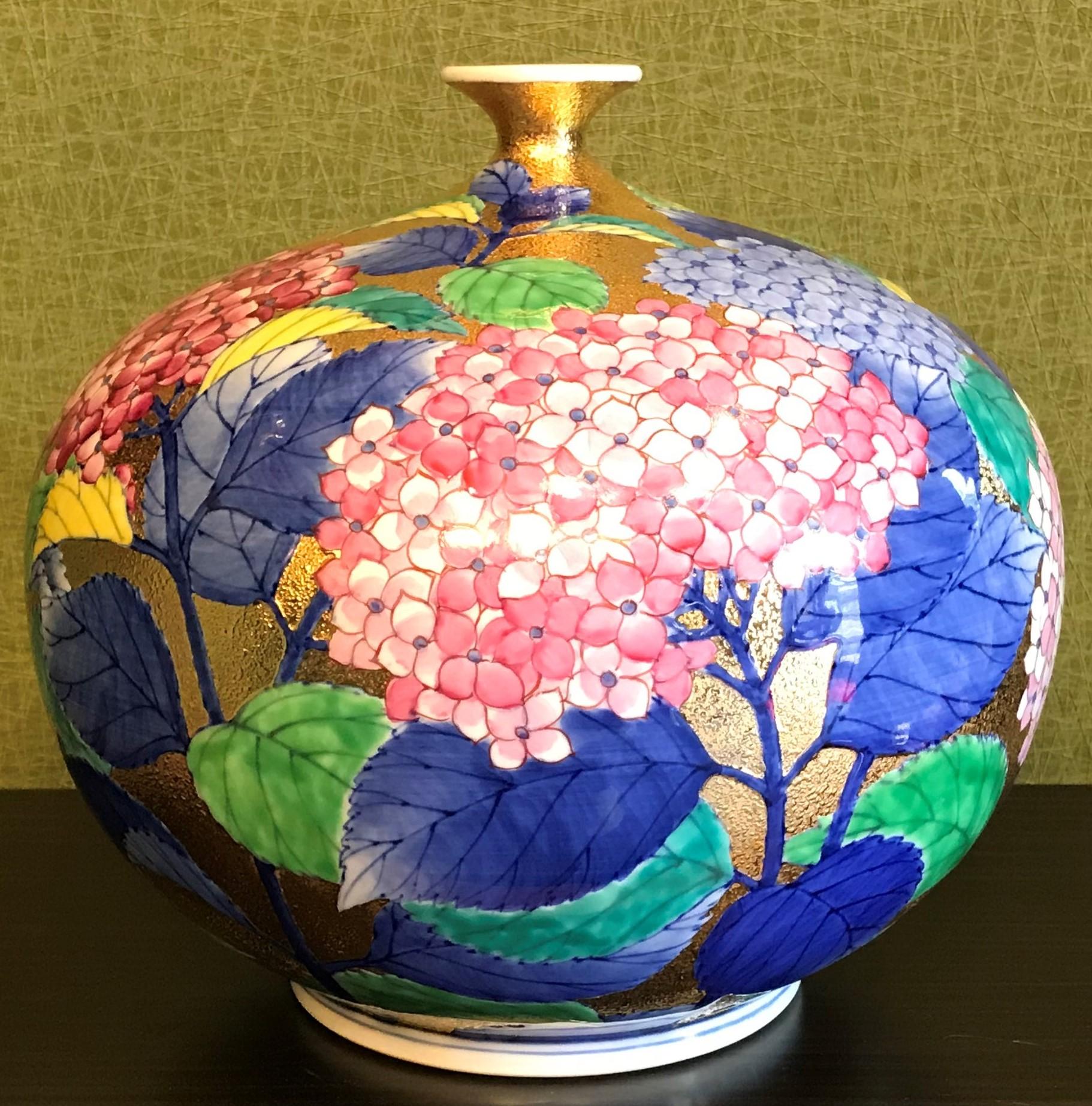  Exceptional contemporary Japanese porcelain vase, gilded and hand painted in pink, red, green, blue and white on an attractive gilded globular body, a signed masterpiece by highly respected award-winning master porcelain artist from Imari-Arita