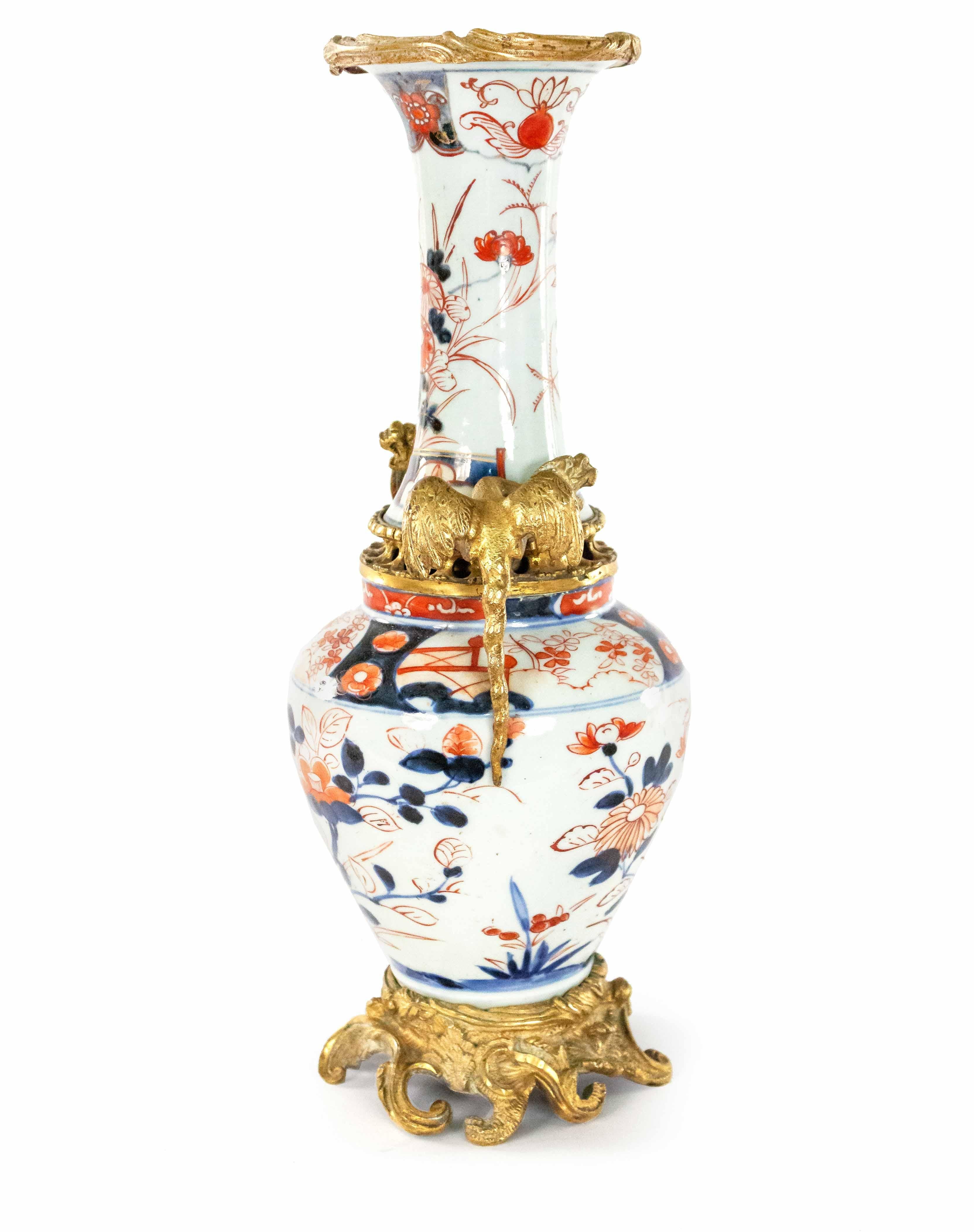 Pair of Asian Japanese Imari rose porcelain shaped vases with decorative gilt bronze dragons flanking each side (19th-20th century).