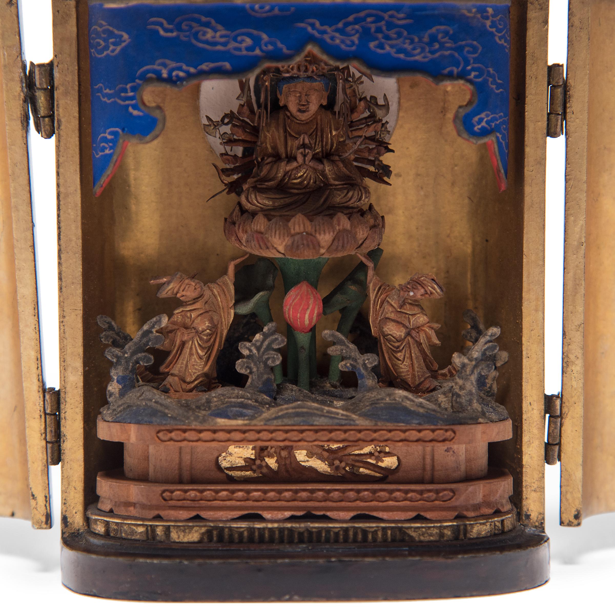 The simple exterior of even black lacquer that encases this Late 19th century Japanese traveling shrine belies the splendor within. The hinged doors open to reveal an intricately carved gilt figure of the bodhisattva Senju Kannon, or 