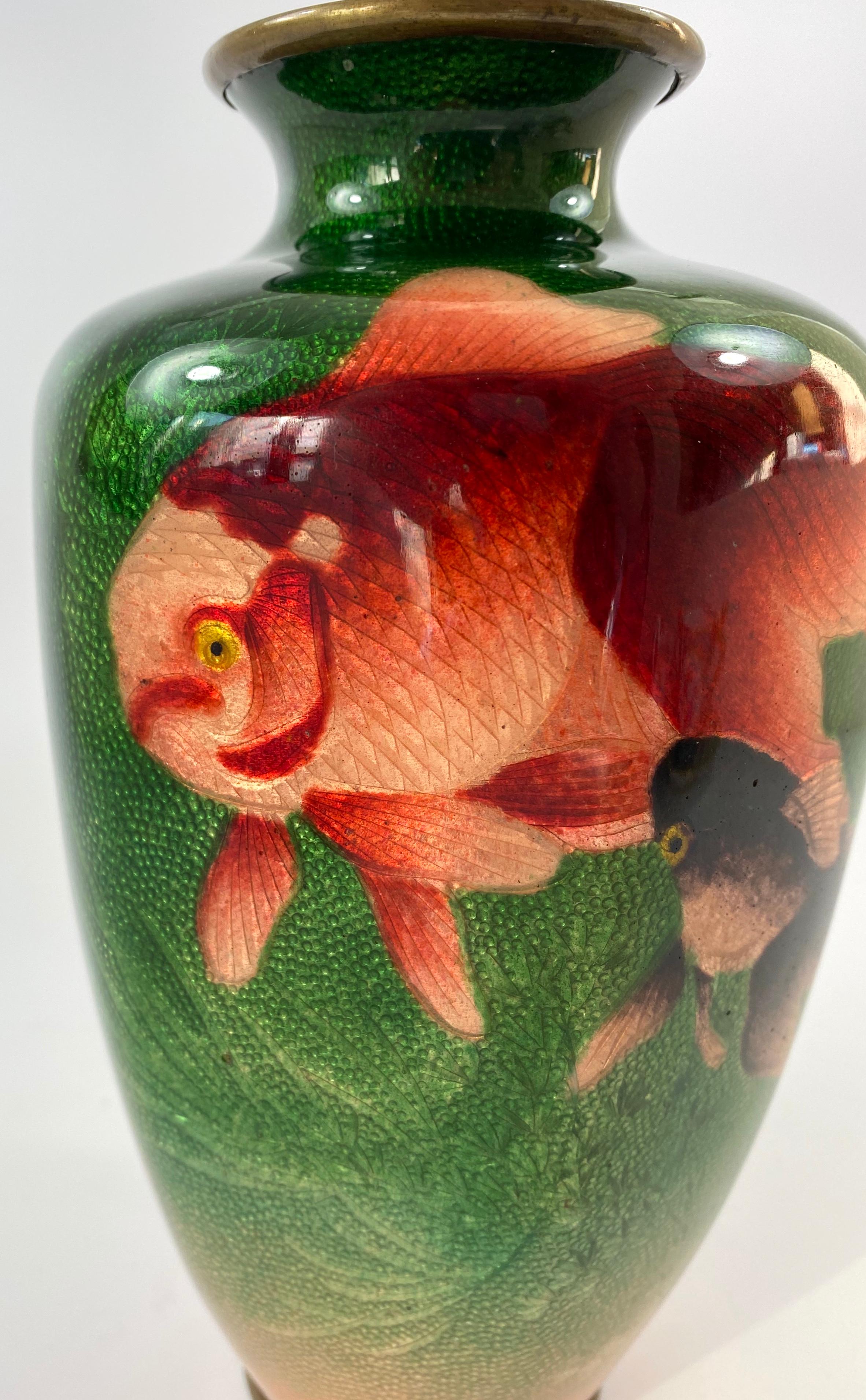 Japanese ginbari cloisonne vase, signed Ota Toshiro, Meiji Period. The hexagonal shaped vase, decorated upon a silver foil ground, with a continuous scene of orange and chocolate brown Oranda fish, swimming amongst seaweed, beneath green enamel.